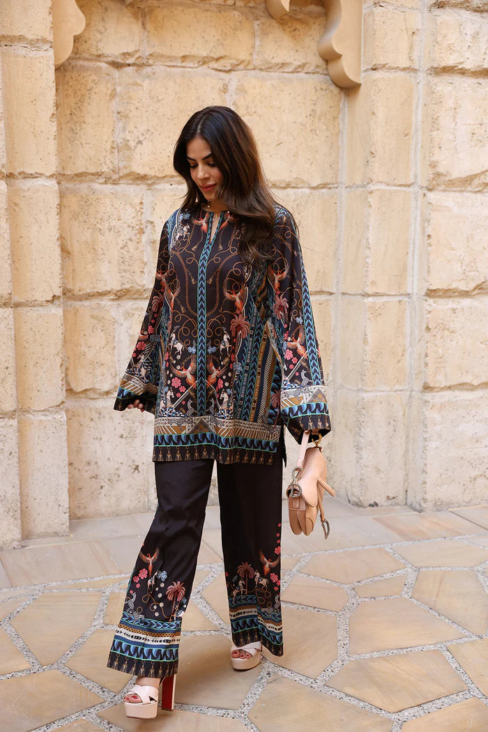 Model wearing black co-ord set with multicolour floral and geometric print from Saira Rizwan, Pakistani Luxury pret, Pakistani clothes online in UK.