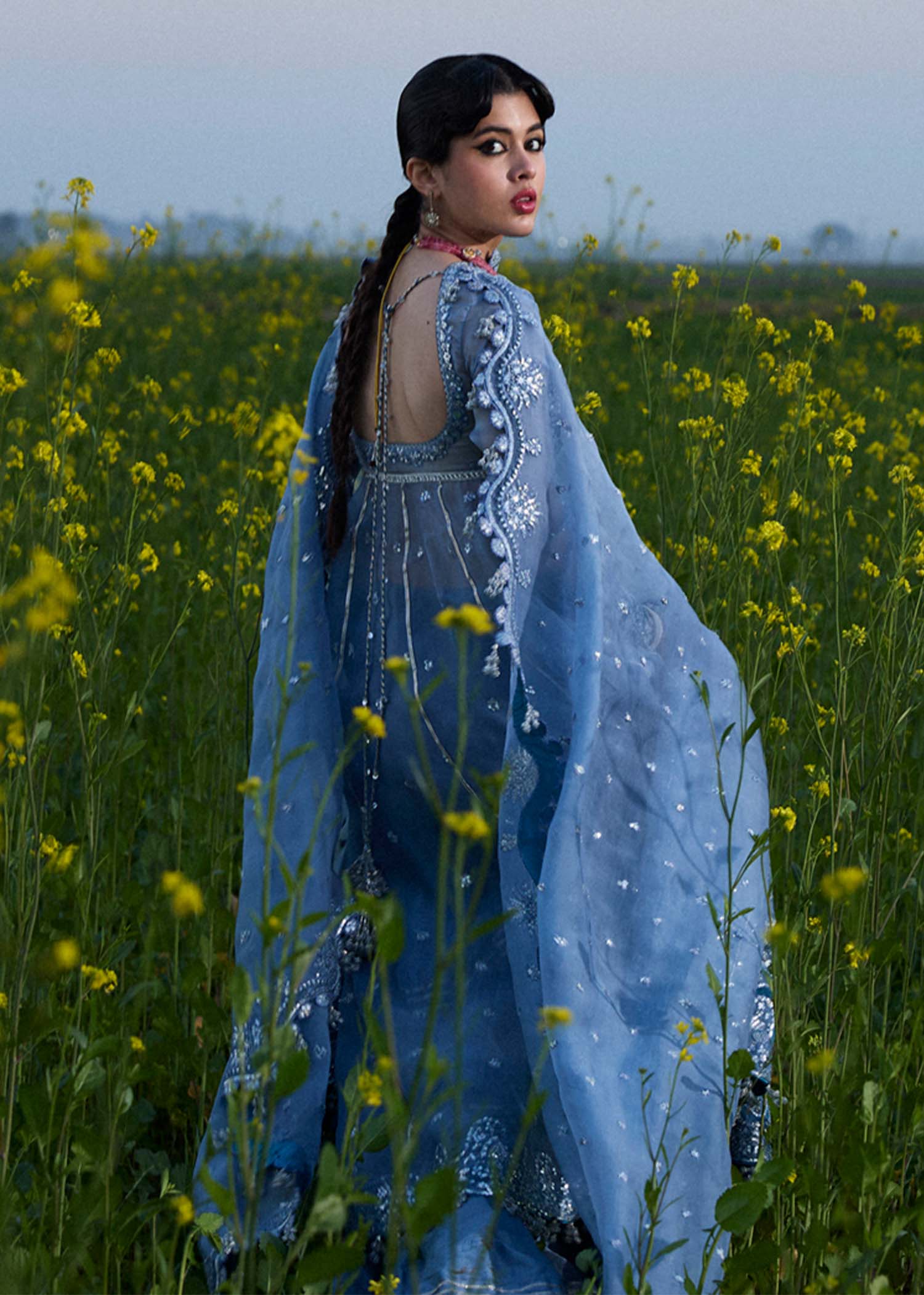 Model wearing Hussain Rehar Mira ice blue embroidered festive dress with intricate embellishments and elegant detailing. Shop Pakistani clothes online in the UK now.