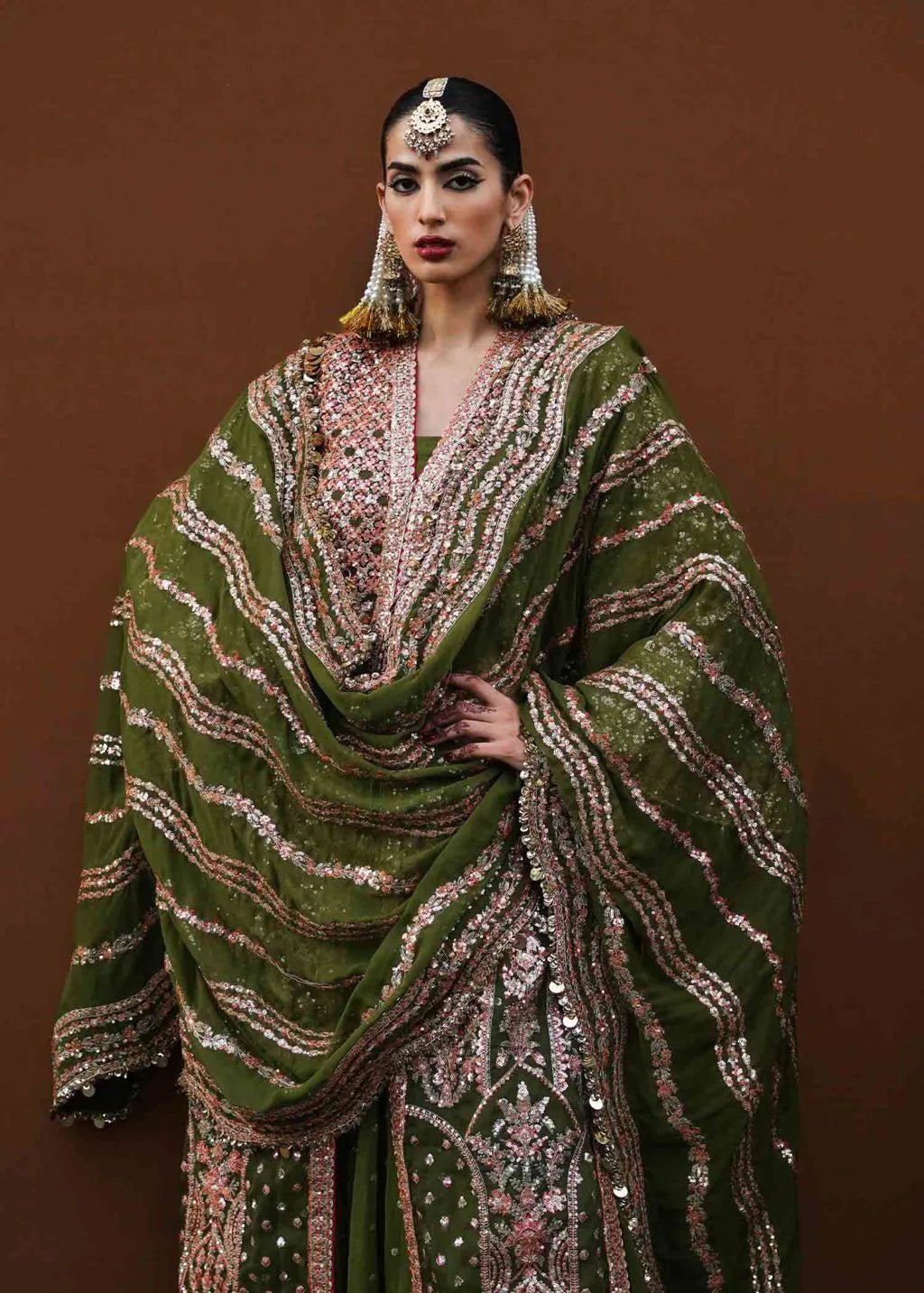 Model wearing green Zaitoon dress from Hussain Rehar Festive Zaib - un - Nisa '23 collection, showcasing Pakistani clothes online in the UK.