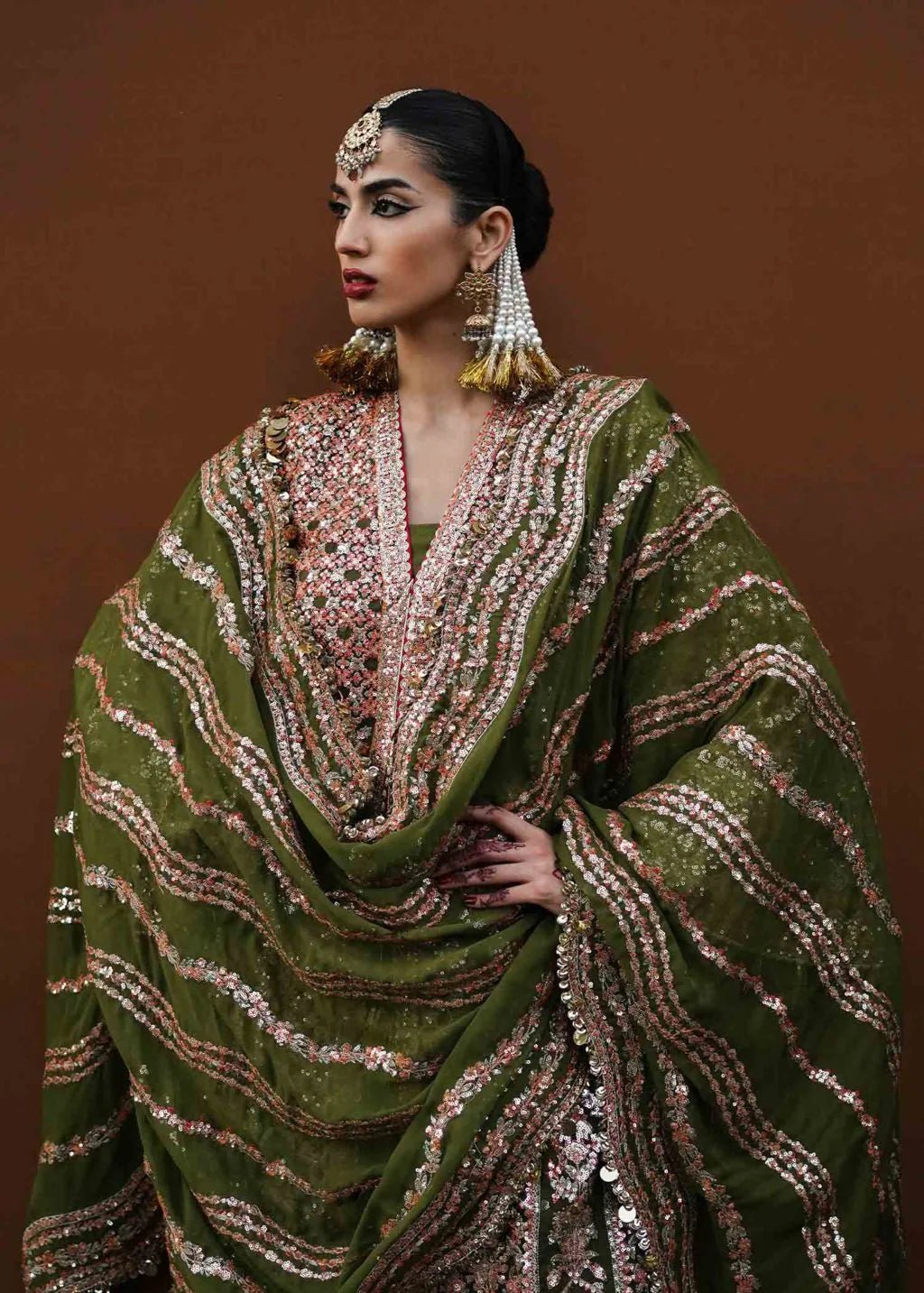 Model wearing green Zaitoon dress from Hussain Rehar Festive Zaib - un - Nisa '23 collection, showcasing Pakistani clothes online in the UK.