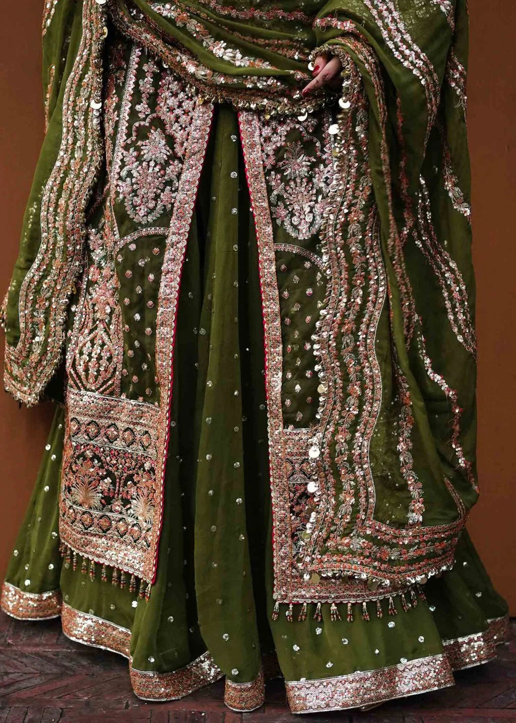 Model wearing green Zaitoon dress from Hussain Rehar Festive Zaib - un - Nisa '23 collection, showcasing Pakistani clothes online in the UK.