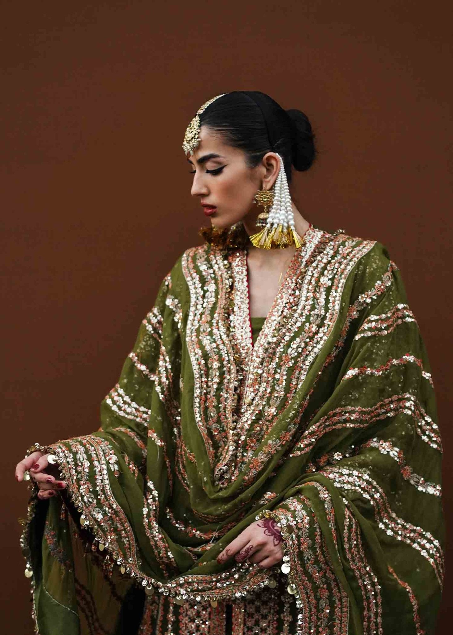 Model wearing green Zaitoon dress from Hussain Rehar Festive Zaib - un - Nisa '23 collection, showcasing Pakistani clothes online in the UK.