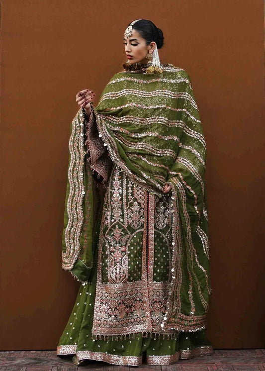 Model in Hussain Rehar UK Zaitoon, draped in green and gold from Festive Zaib - un - Nisa '23 collection.