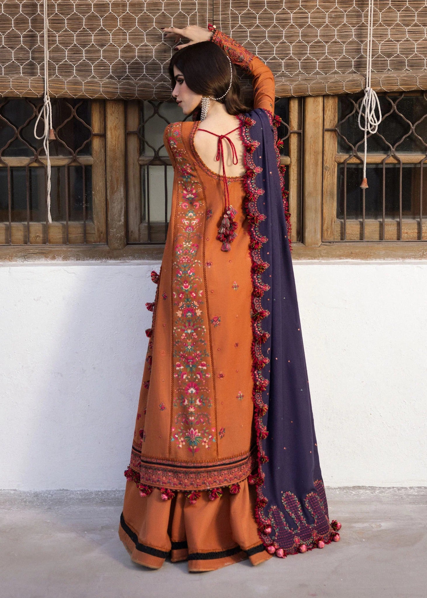 Model wearing Kamal from Hussain Rehar's Karandi AW '24, showcasing luxury Pakistani clothes online in UK.