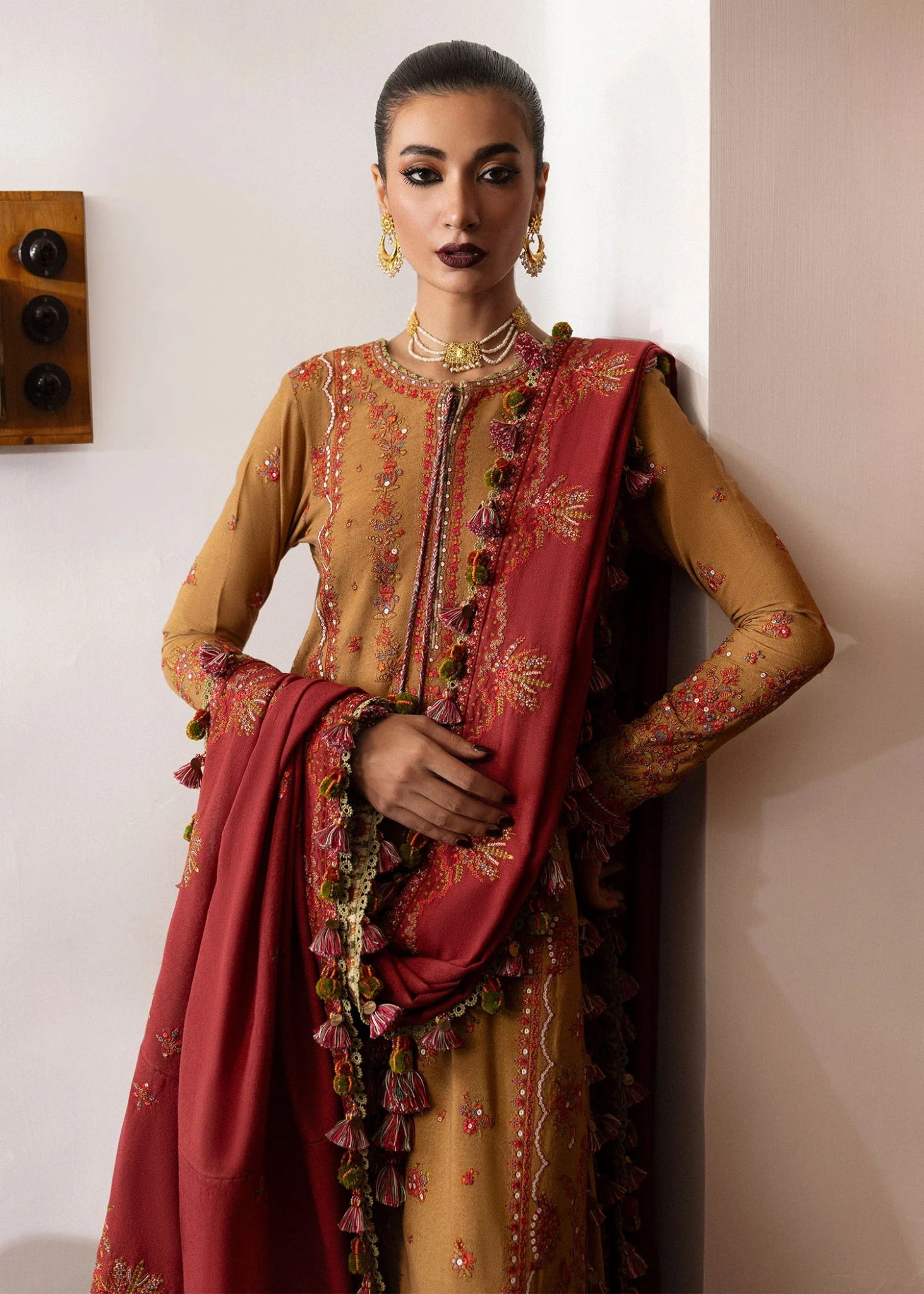 Model wearing Tawn from Hussain Rehar's Karandi AW '24, showcasing luxury Pakistani clothes online in UK.