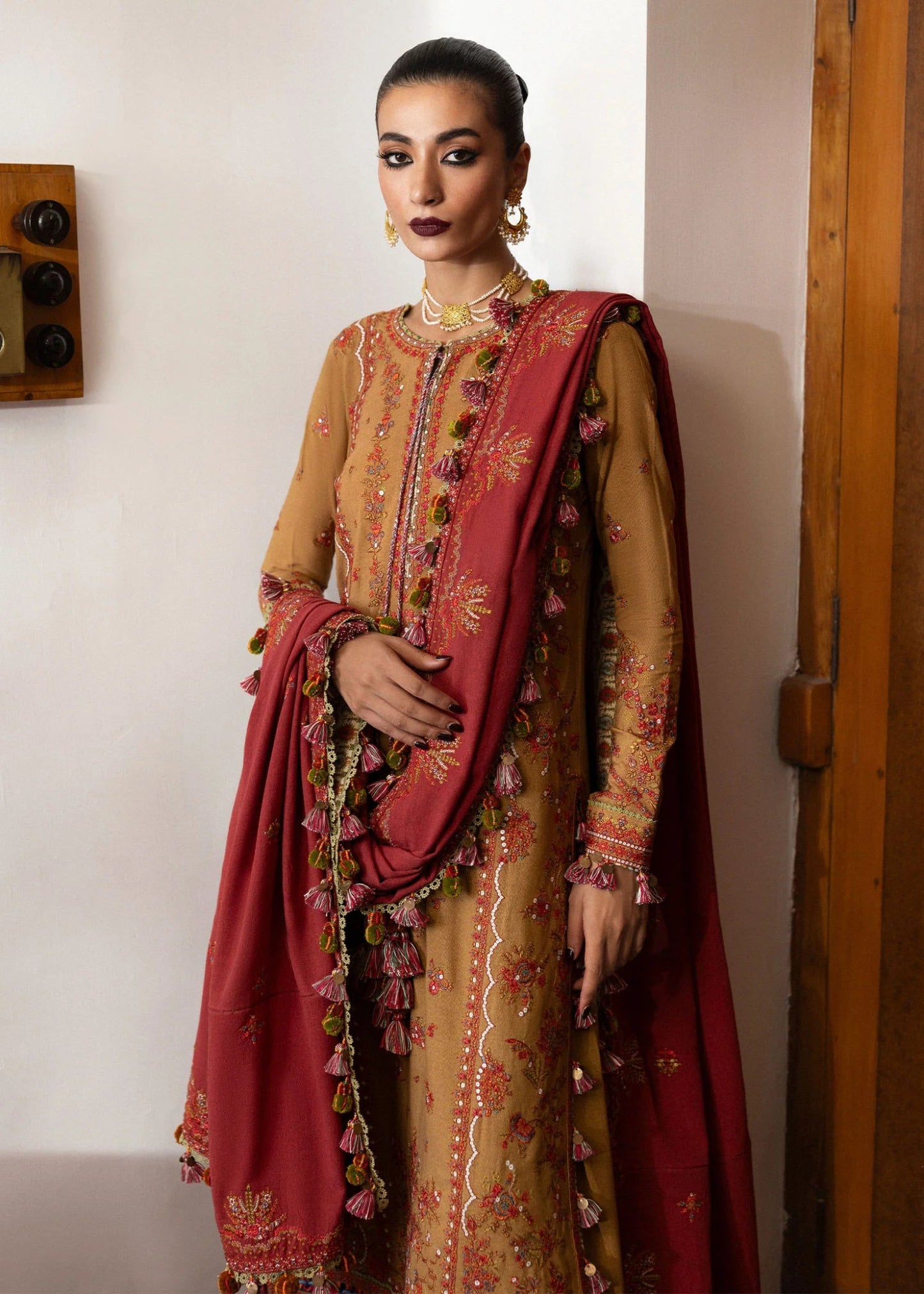 Model wearing Tawn from Hussain Rehar's Karandi AW '24, showcasing luxury Pakistani clothes online in UK.