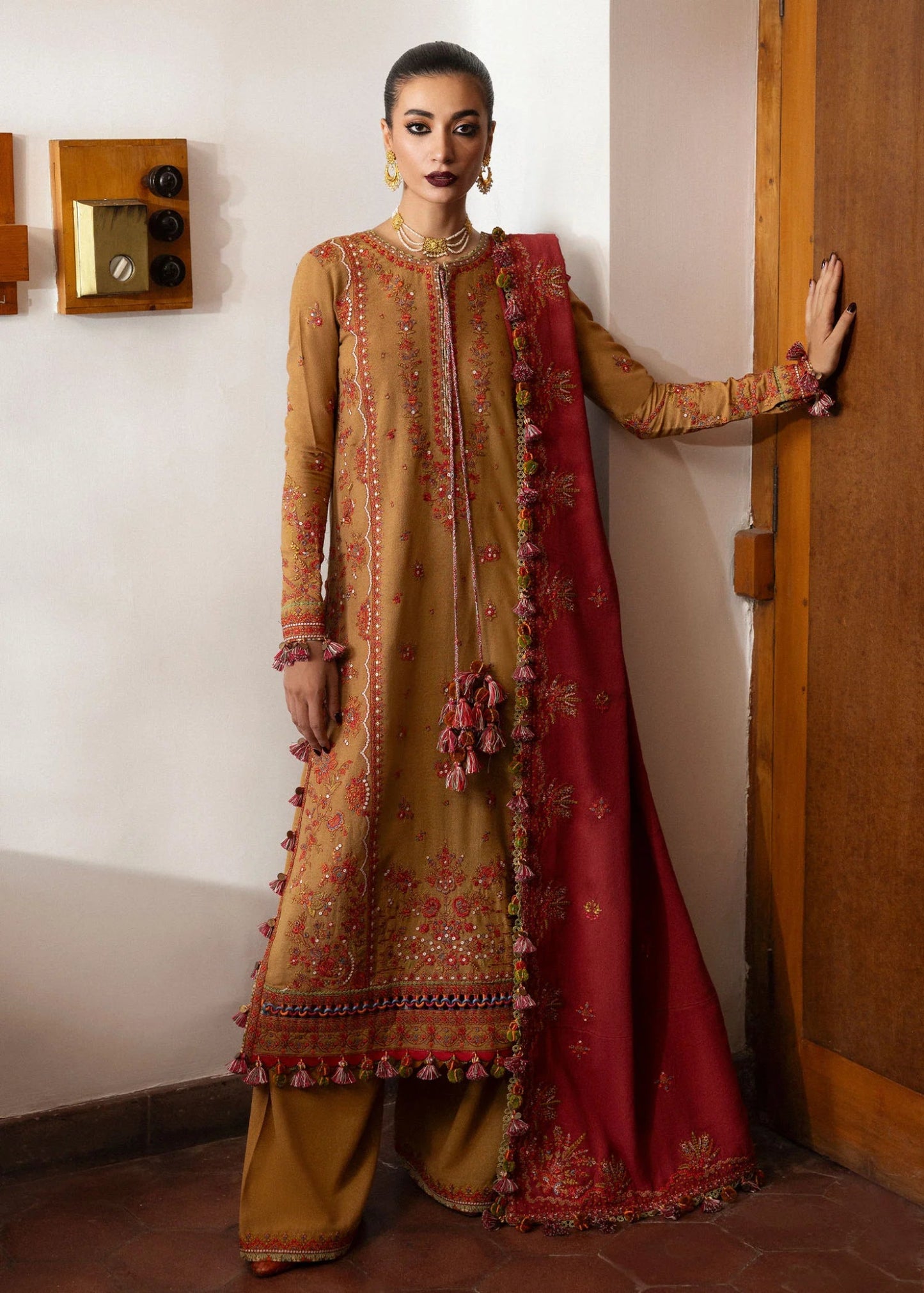 Model wearing Tawn from Hussain Rehar's Karandi AW '24, showcasing luxury Pakistani clothes online in UK.