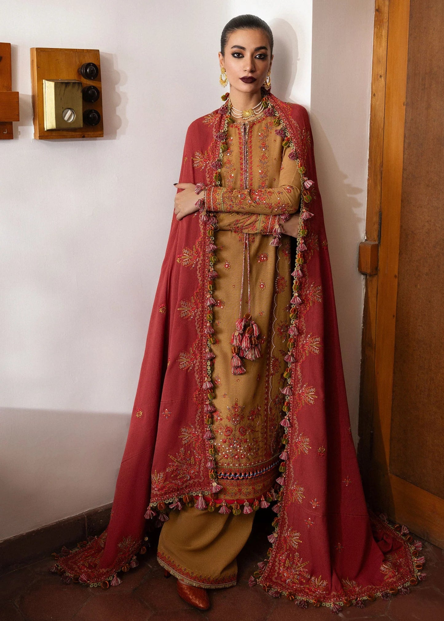 Model wearing Tawn from Hussain Rehar's Karandi AW '24, showcasing luxury Pakistani clothes online in UK.