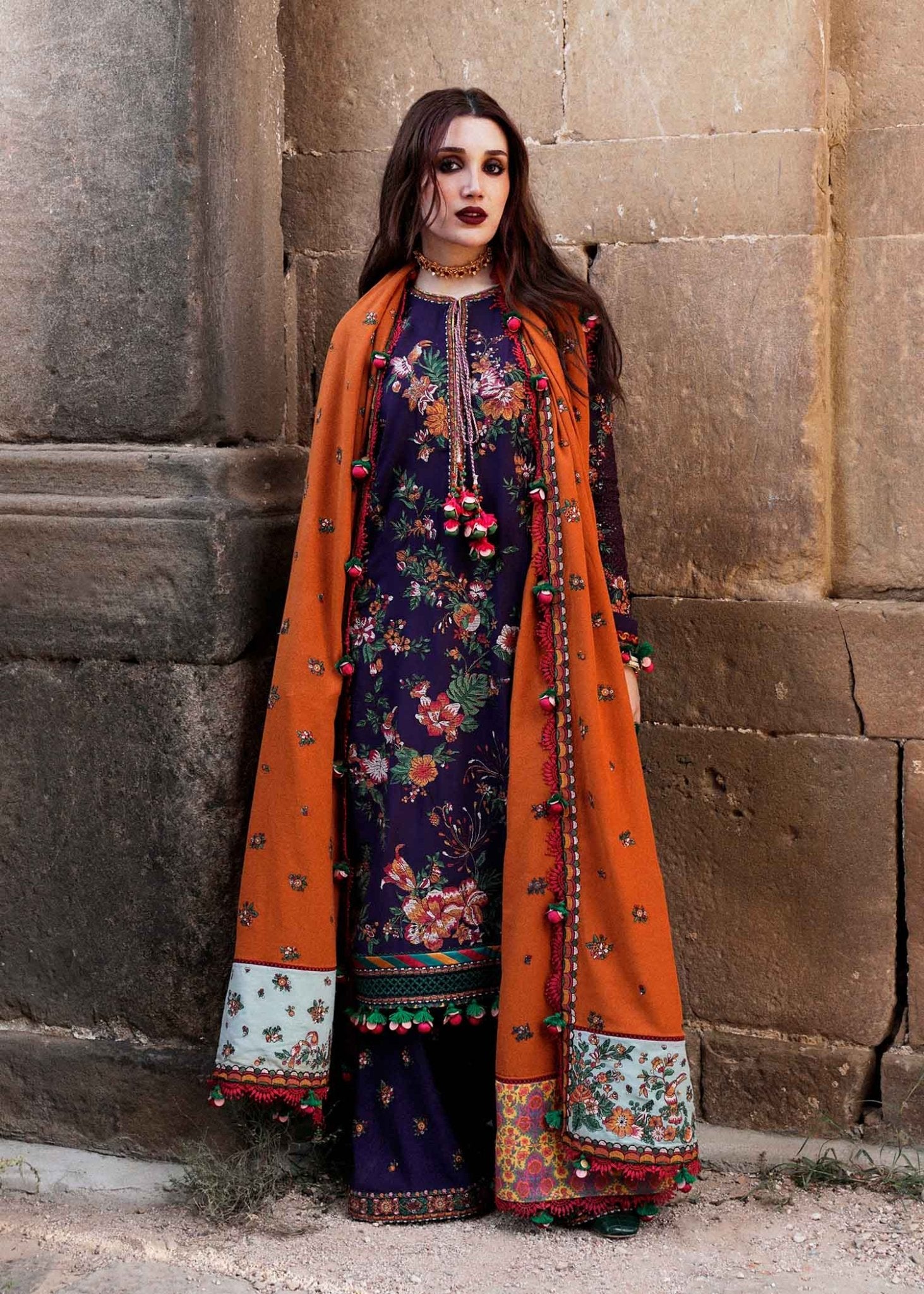 Model in vibrant Hussain Rehar UK Amethyst, floral embroidered coat from Karandi Aw'23 collection.