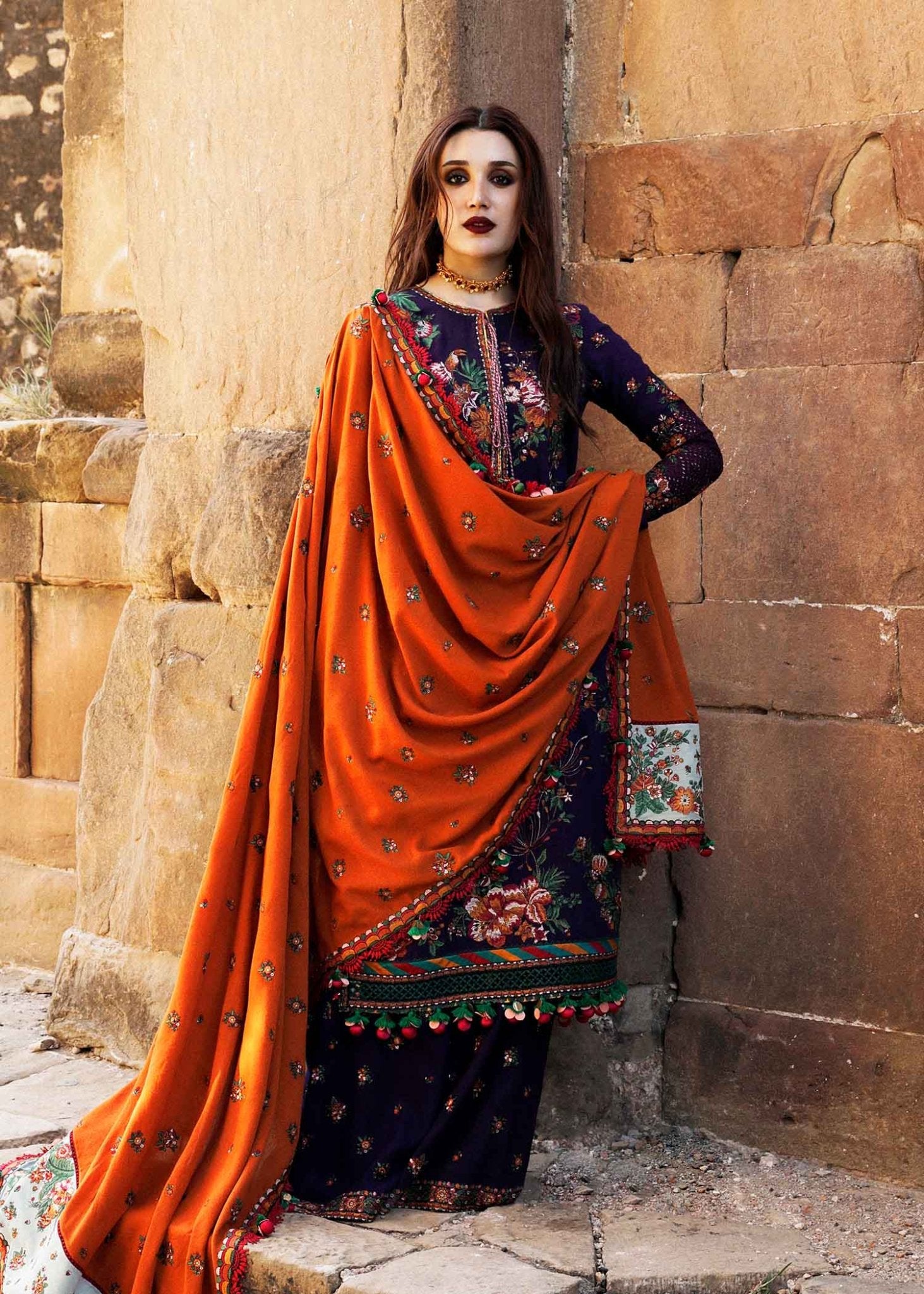 Model wearing Hussain Rehar Karandi Aw'23 Amethyst dress in navy with orange dupatta, showcasing Pakistani clothes online in the UK.