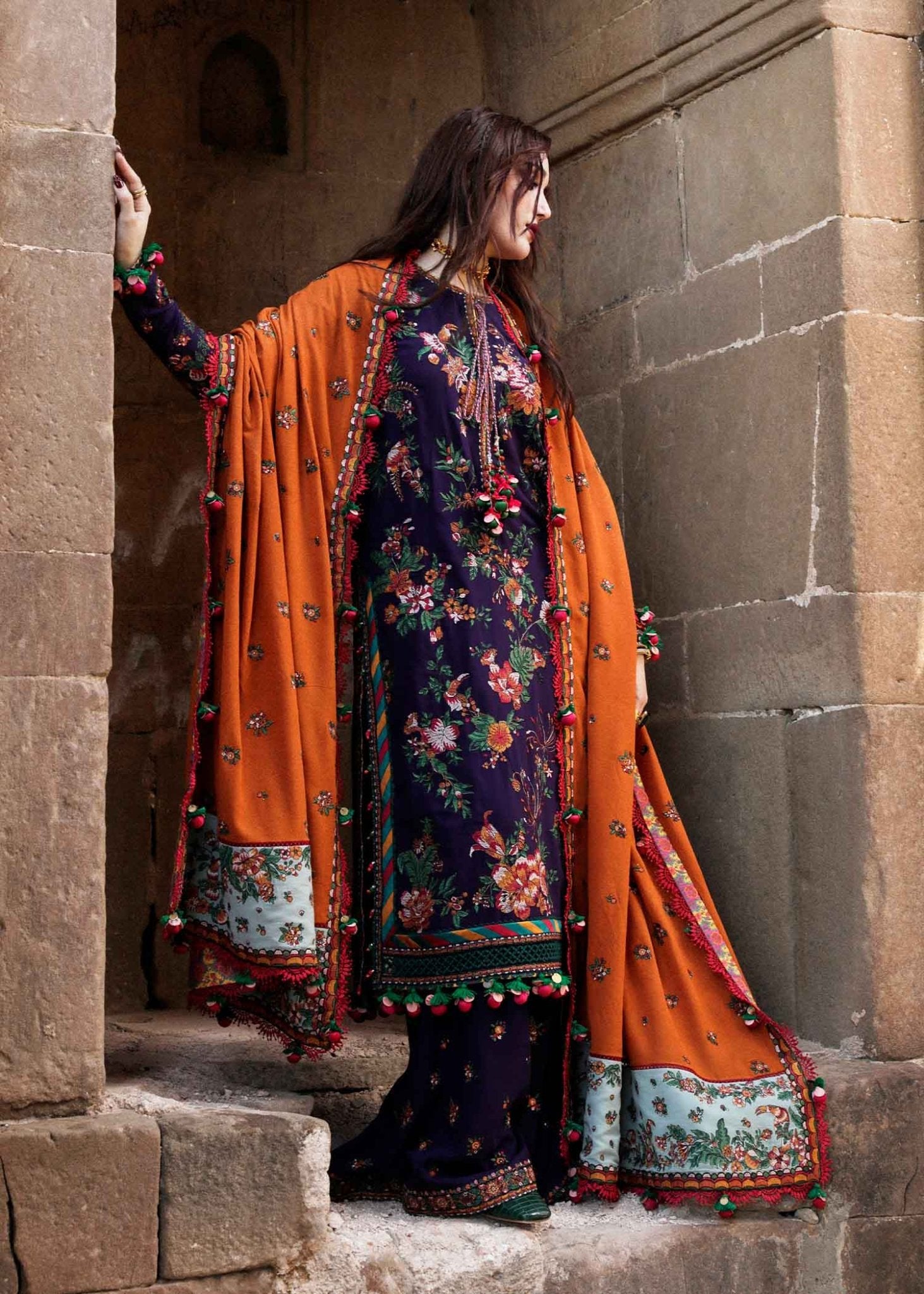 Model wearing Hussain Rehar Karandi Aw'23 Amethyst dress in navy with orange dupatta, showcasing Pakistani clothes online in the UK.