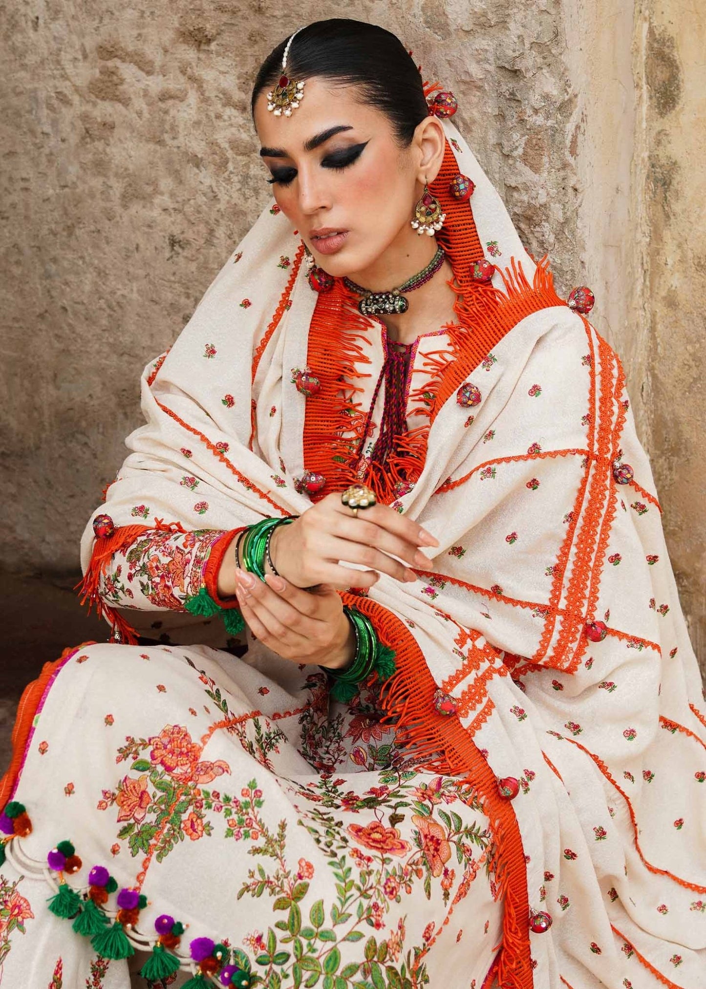 Model wearing Hussain Rehar Karandi Aw'23 Bellis dress in cream with floral patterns, showcasing Pakistani clothes online in the UK.