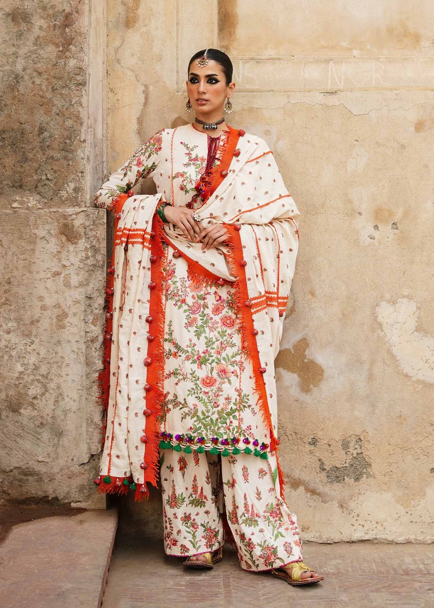 Model wearing Hussain Rehar Karandi Aw'23 Bellis dress in cream with floral patterns, showcasing Pakistani clothes online in the UK.