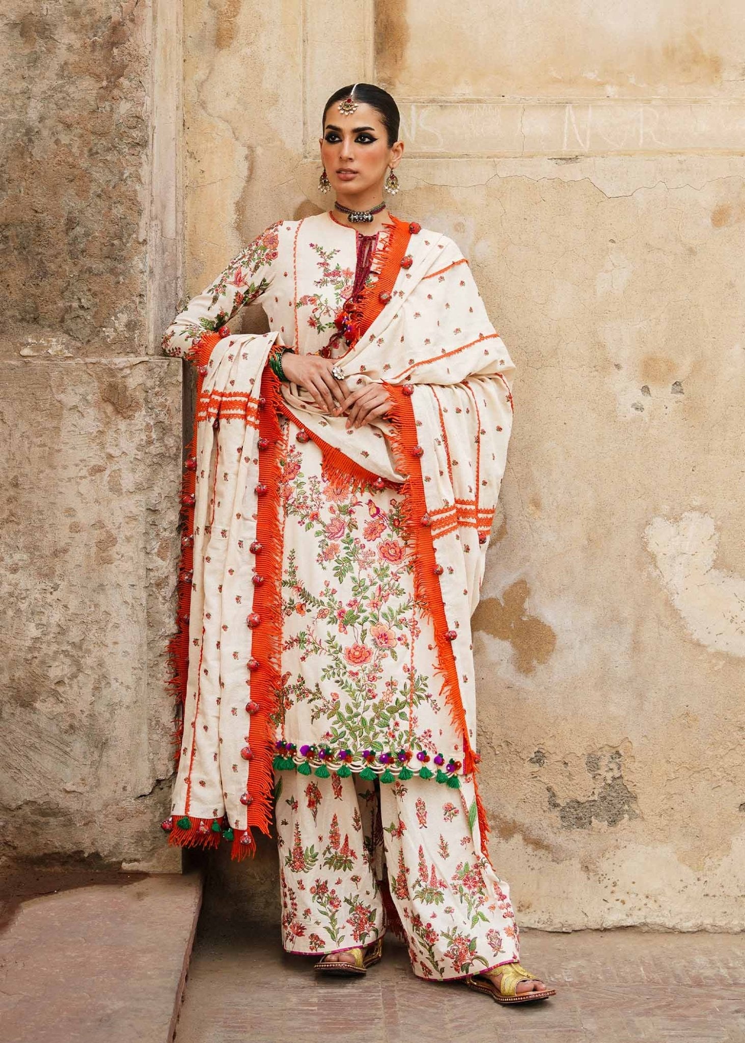 Model wearing Hussain Rehar Karandi Aw'23 Bellis dress in cream with floral patterns, showcasing Pakistani clothes online in the UK.