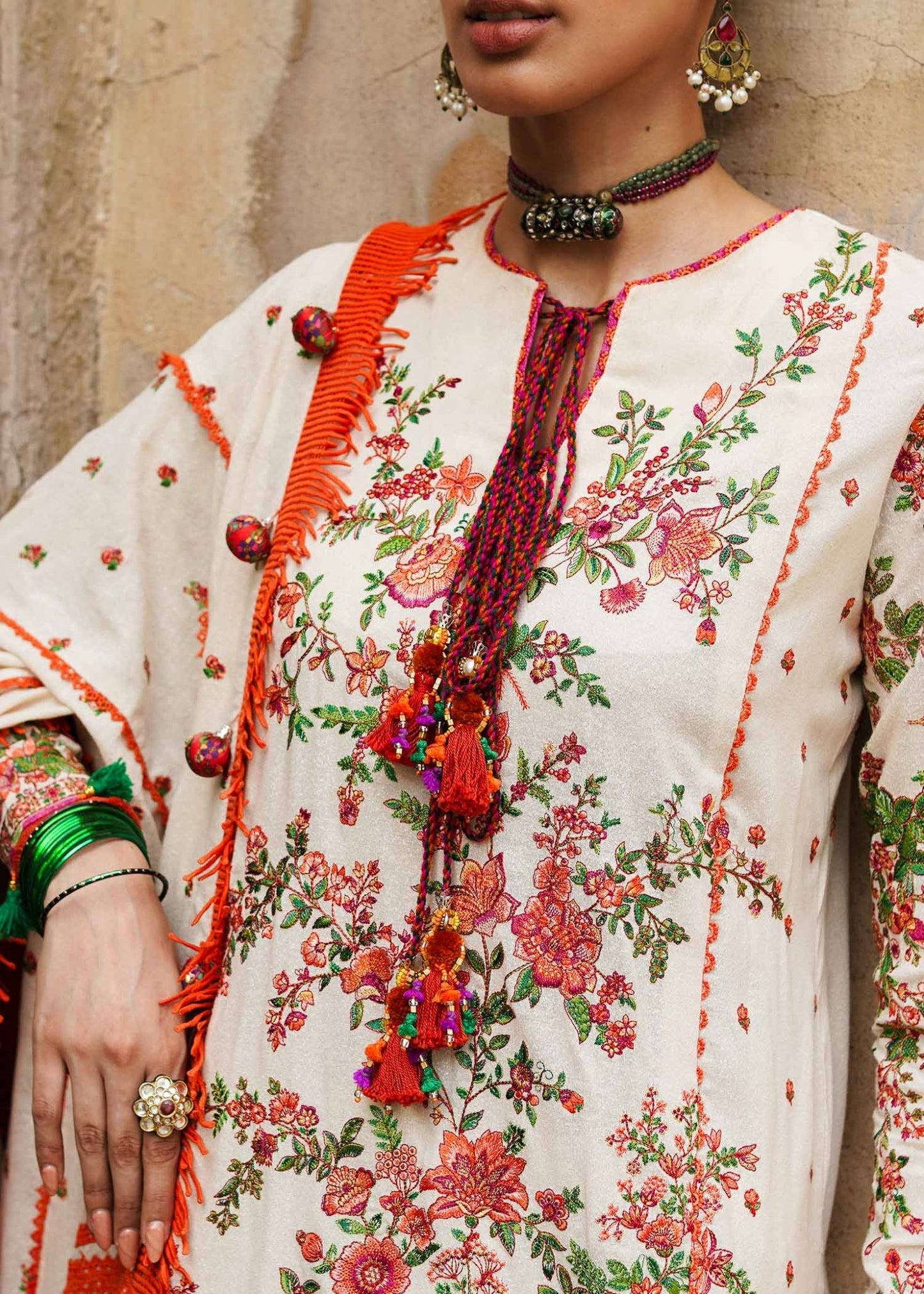 Model wearing Hussain Rehar Karandi Aw'23 Bellis dress in cream with floral patterns, showcasing Pakistani clothes online in the UK.