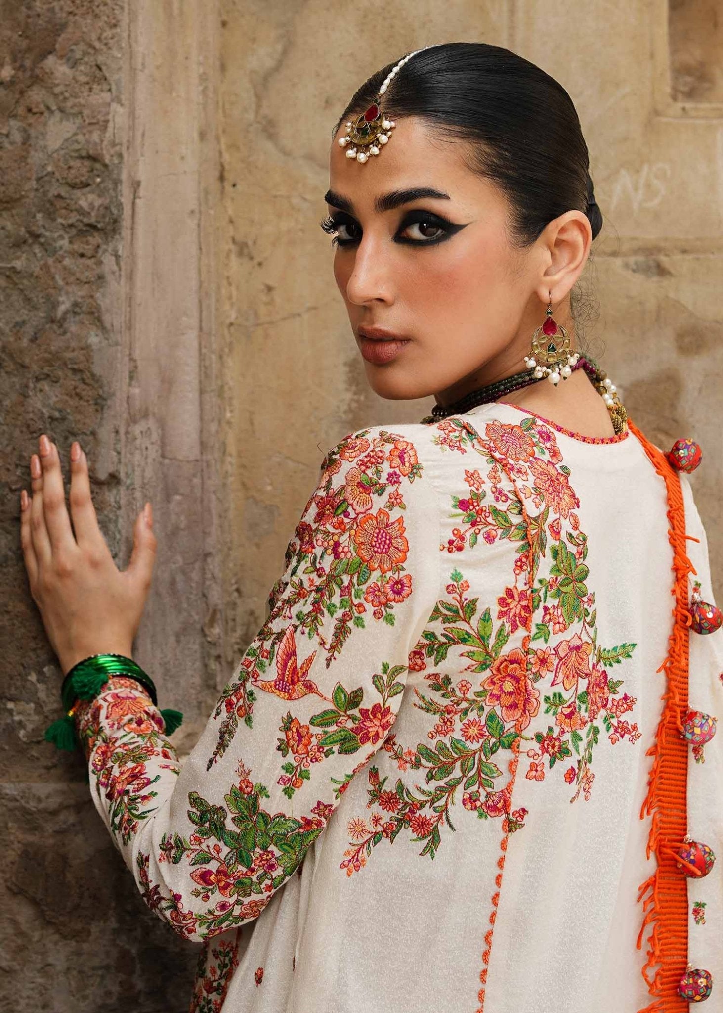 Model wearing Hussain Rehar Karandi Aw'23 Bellis dress in cream with floral patterns, showcasing Pakistani clothes online in the UK.