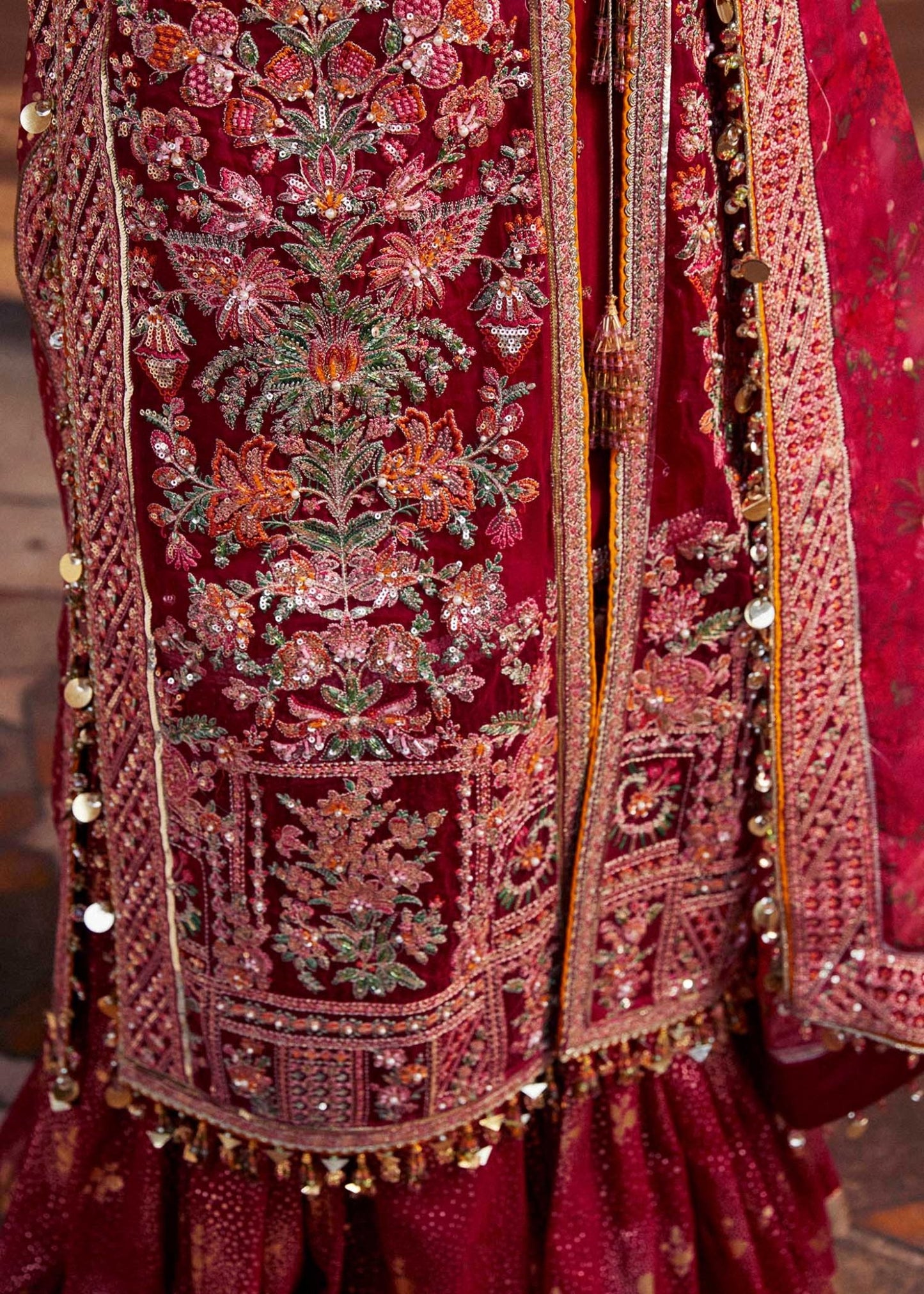 Model wearing red Gulal dress from Hussain Rehar Luxury Festive FW/24, featuring intricate embroidery. Pakistani clothes online UK.