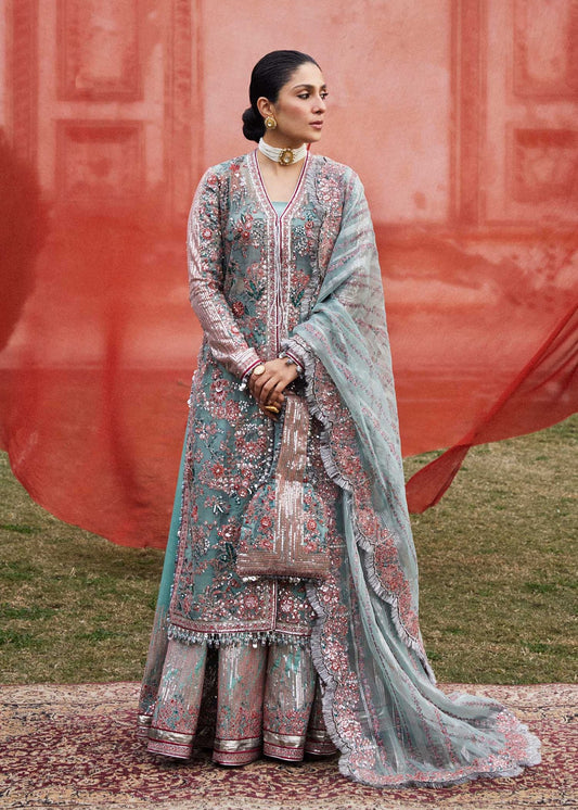 Model wearing light blue Saleen dress from Hussain Rehar Luxury Festive FW/24, showcasing intricate pink and silver embroidery. Pakistani clothes online in the UK.