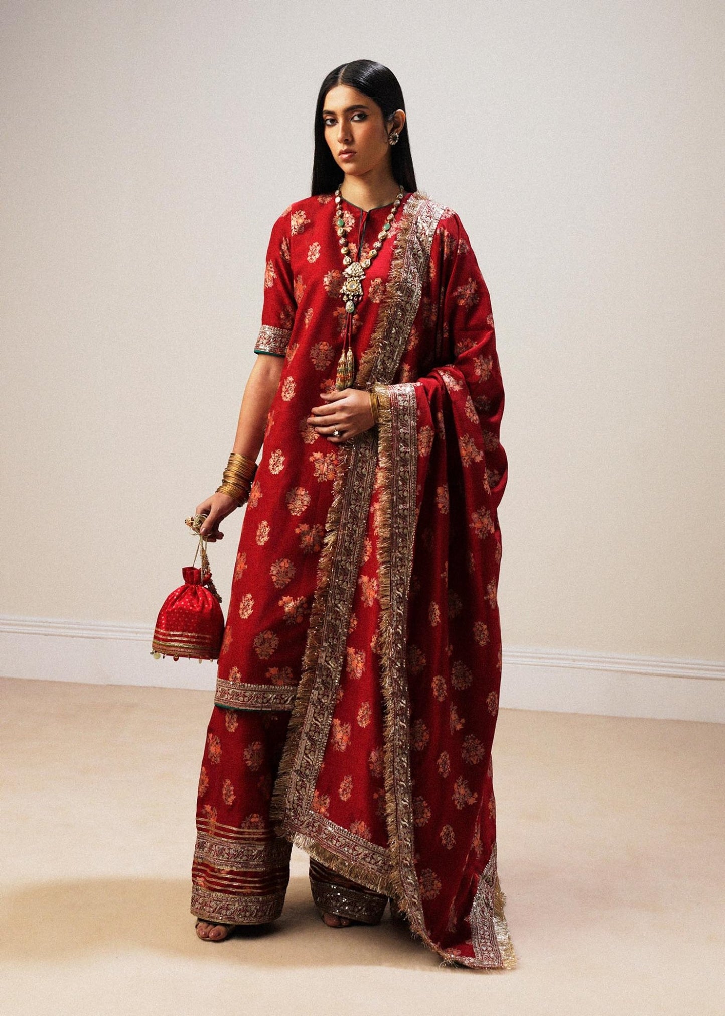 Model wearing red Sahar dress from Hussain Rehar Luxury Pret A/W 2024, showcasing Pakistani clothes online in the UK.