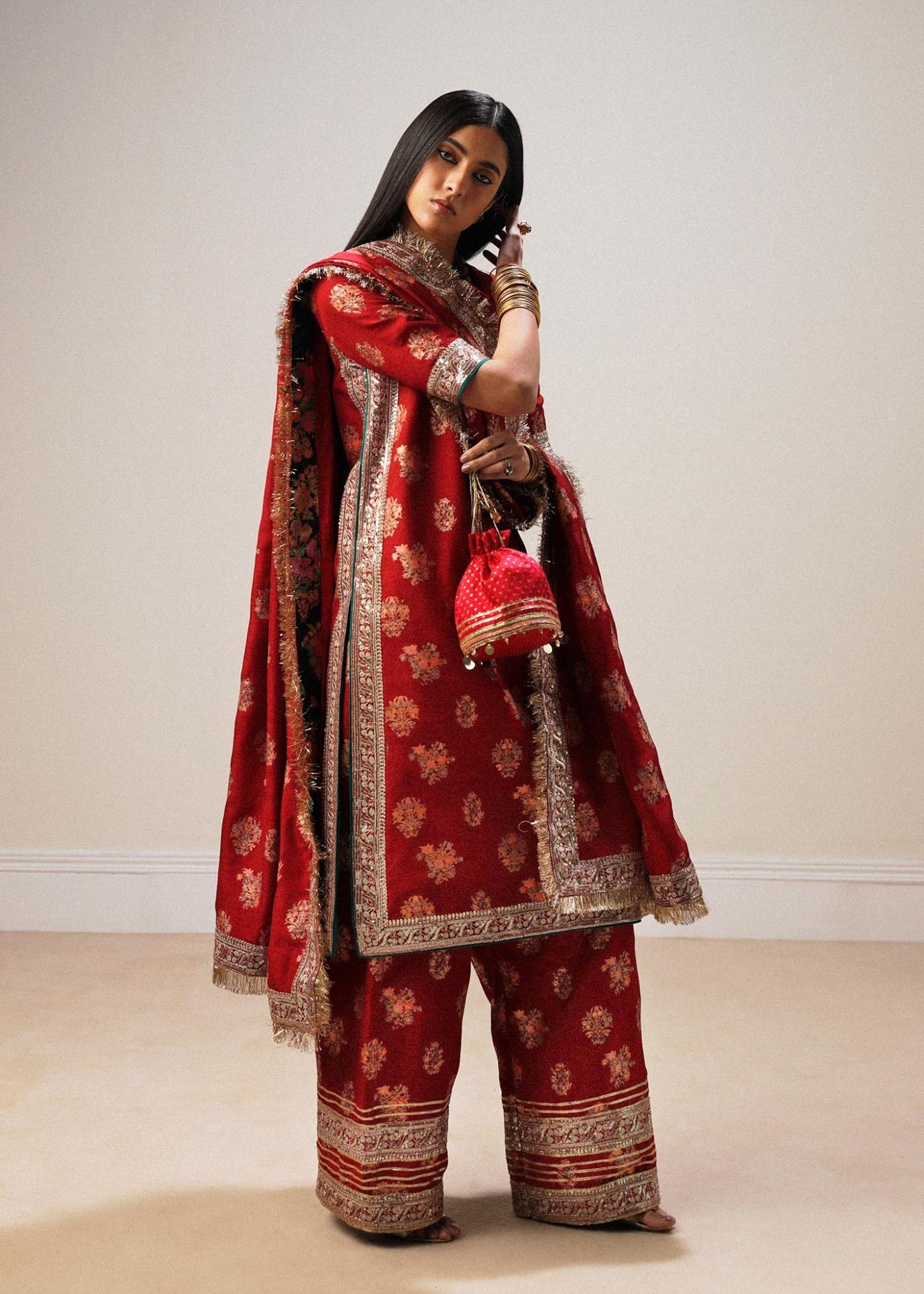 Model wearing red Sahar dress from Hussain Rehar Luxury Pret A/W 2024, showcasing Pakistani clothes online in the UK.