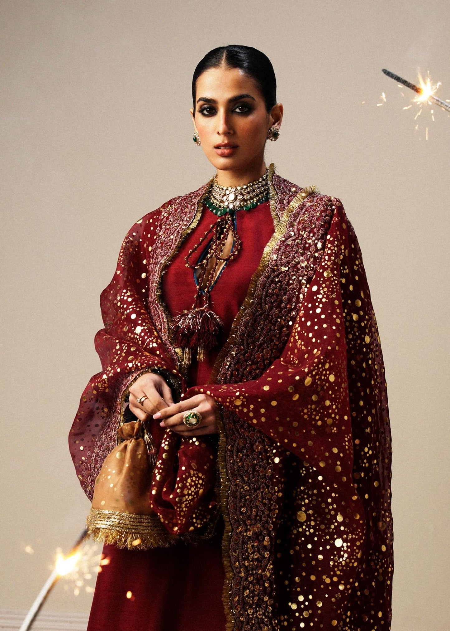 Model wearing maroon Surkh dress from Hussain Rehar, showcasing luxurious embroidery and intricate detailing. Ideal for Pakistani designer clothes in the UK, readymade clothing, and elegant festive wear.