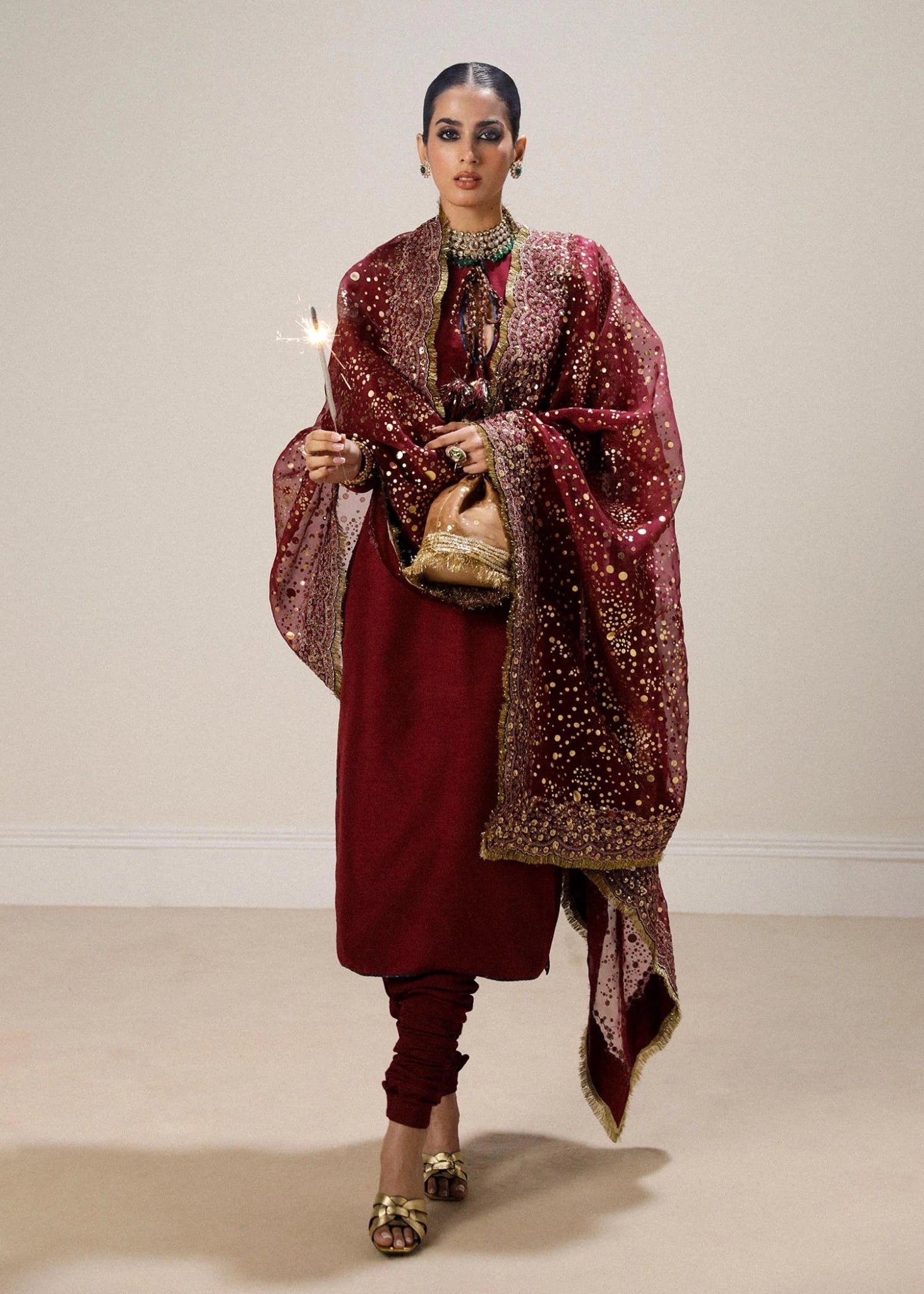 Model wearing maroon Surkh dress from Hussain Rehar, showcasing luxurious embroidery and intricate detailing. Ideal for Pakistani designer clothes in the UK, readymade clothing, and elegant festive wear.