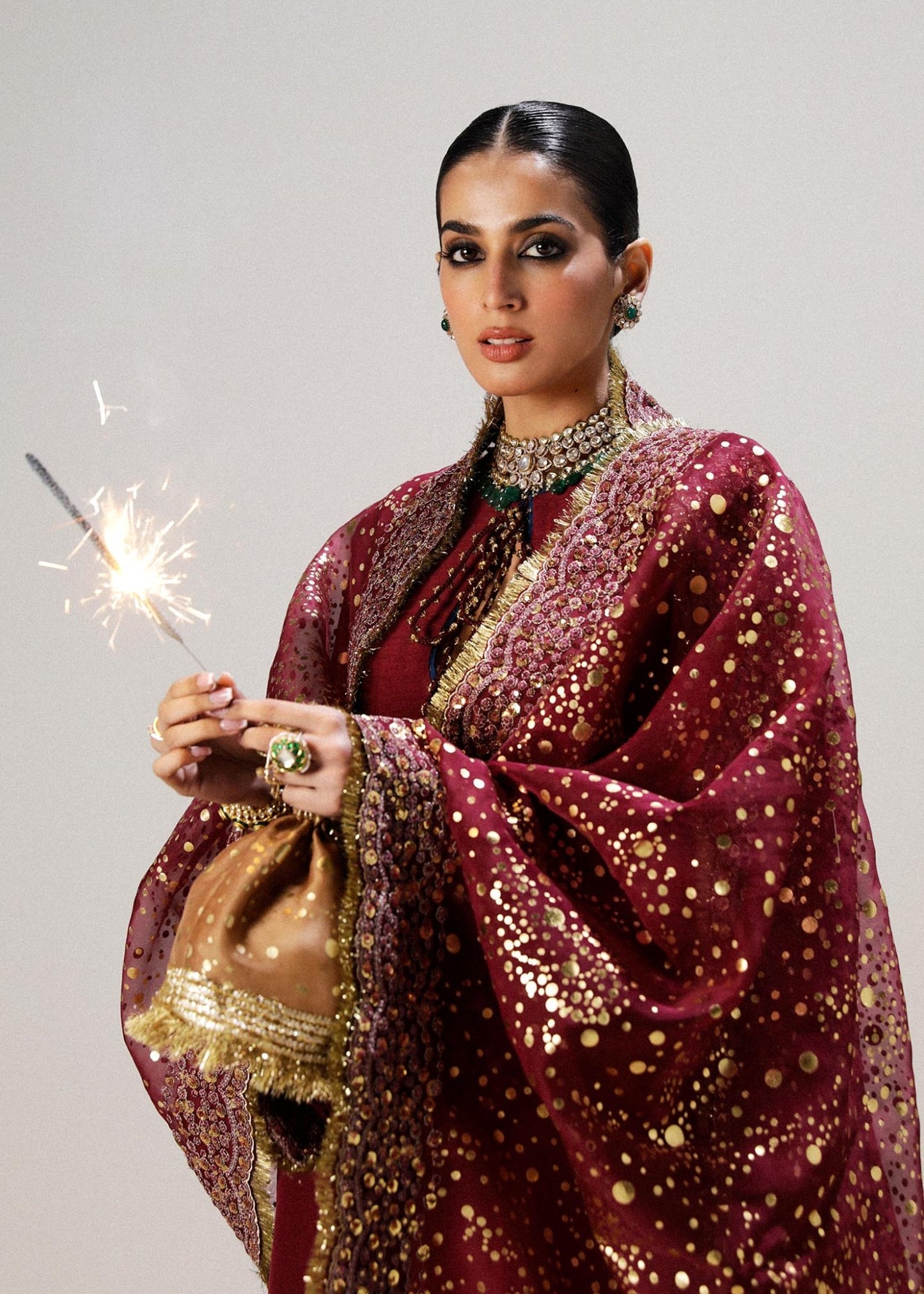 Model wearing maroon Surkh dress from Hussain Rehar, showcasing luxurious embroidery and intricate detailing. Ideal for Pakistani designer clothes in the UK, readymade clothing, and elegant festive wear.