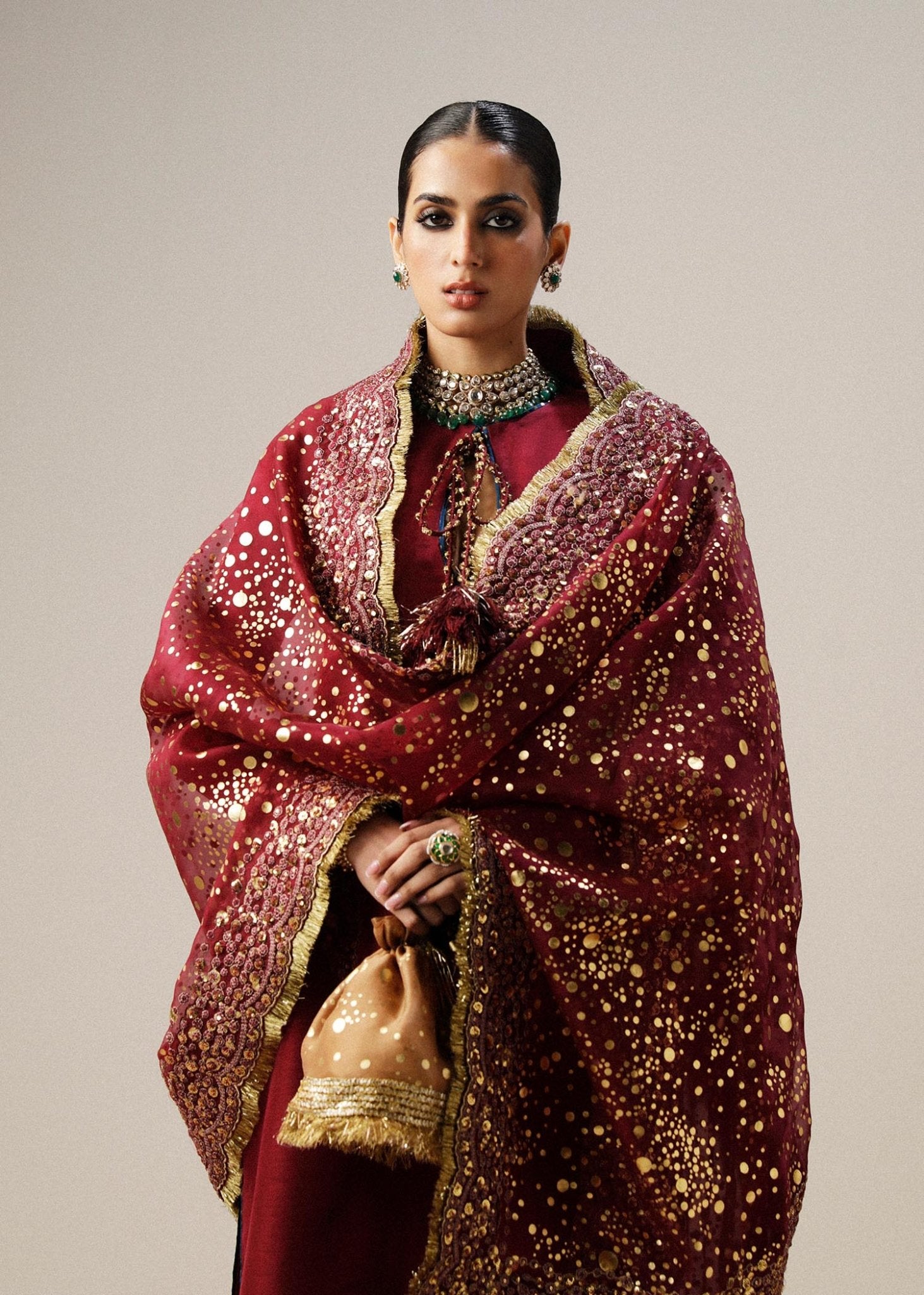 Model wearing maroon Surkh dress from Hussain Rehar, showcasing luxurious embroidery and intricate detailing. Ideal for Pakistani designer clothes in the UK, readymade clothing, and elegant festive wear.