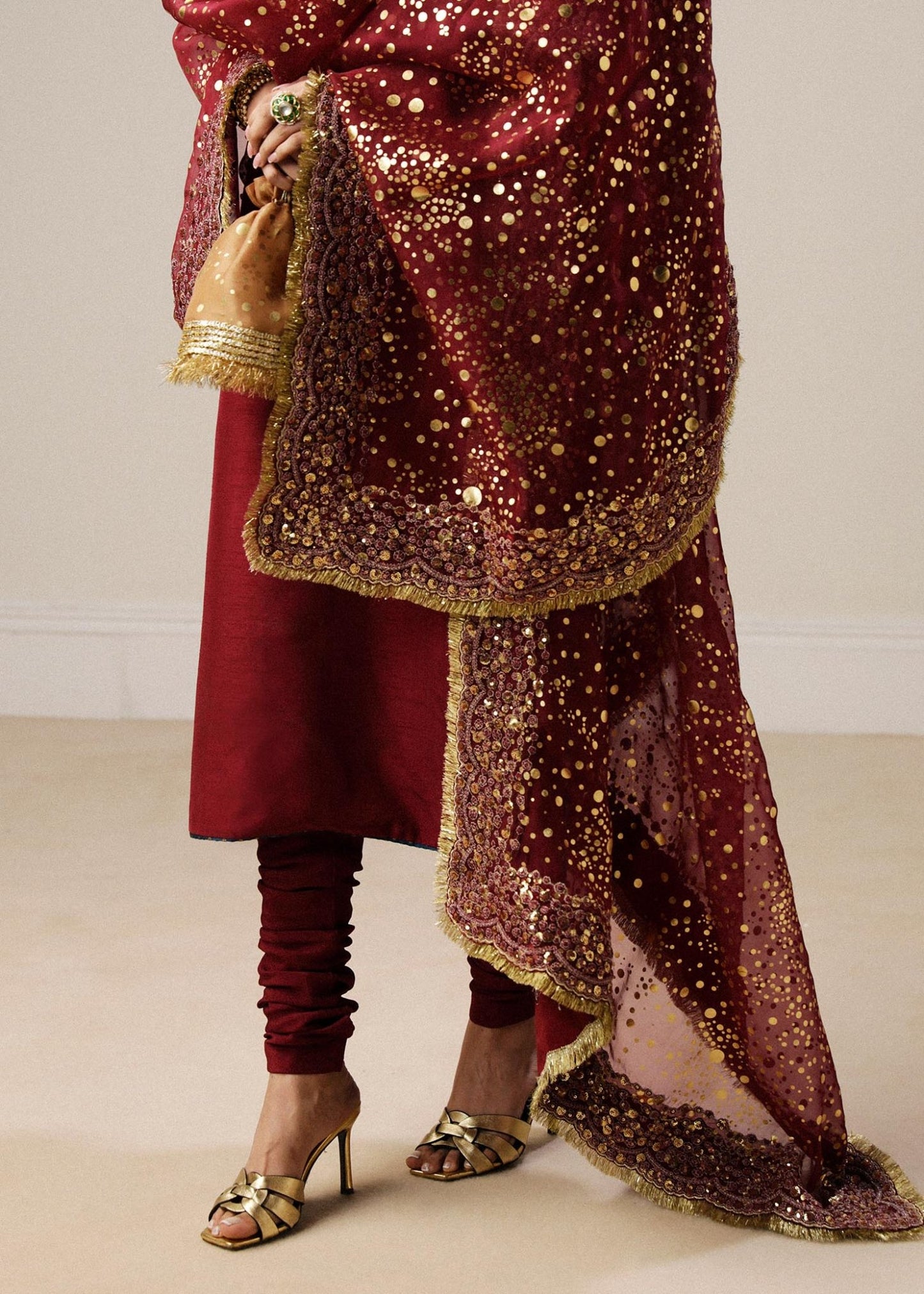 Model wearing maroon Surkh dress from Hussain Rehar, showcasing luxurious embroidery and intricate detailing. Ideal for Pakistani designer clothes in the UK, readymade clothing, and elegant festive wear.