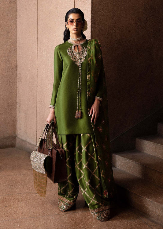 Model wearing Hussain Rehar Celeine dress in green, perfect for Pakistani designer clothes in UK, readymade wedding clothes, highlighting luxury details for Eid '24.