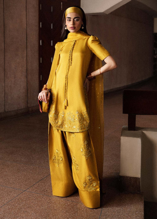 Model wearing a vibrant yellow Maize dress from Hussain Rehar's Luxury Pret Eid '24 collection. Pakistani clothes online in UK.