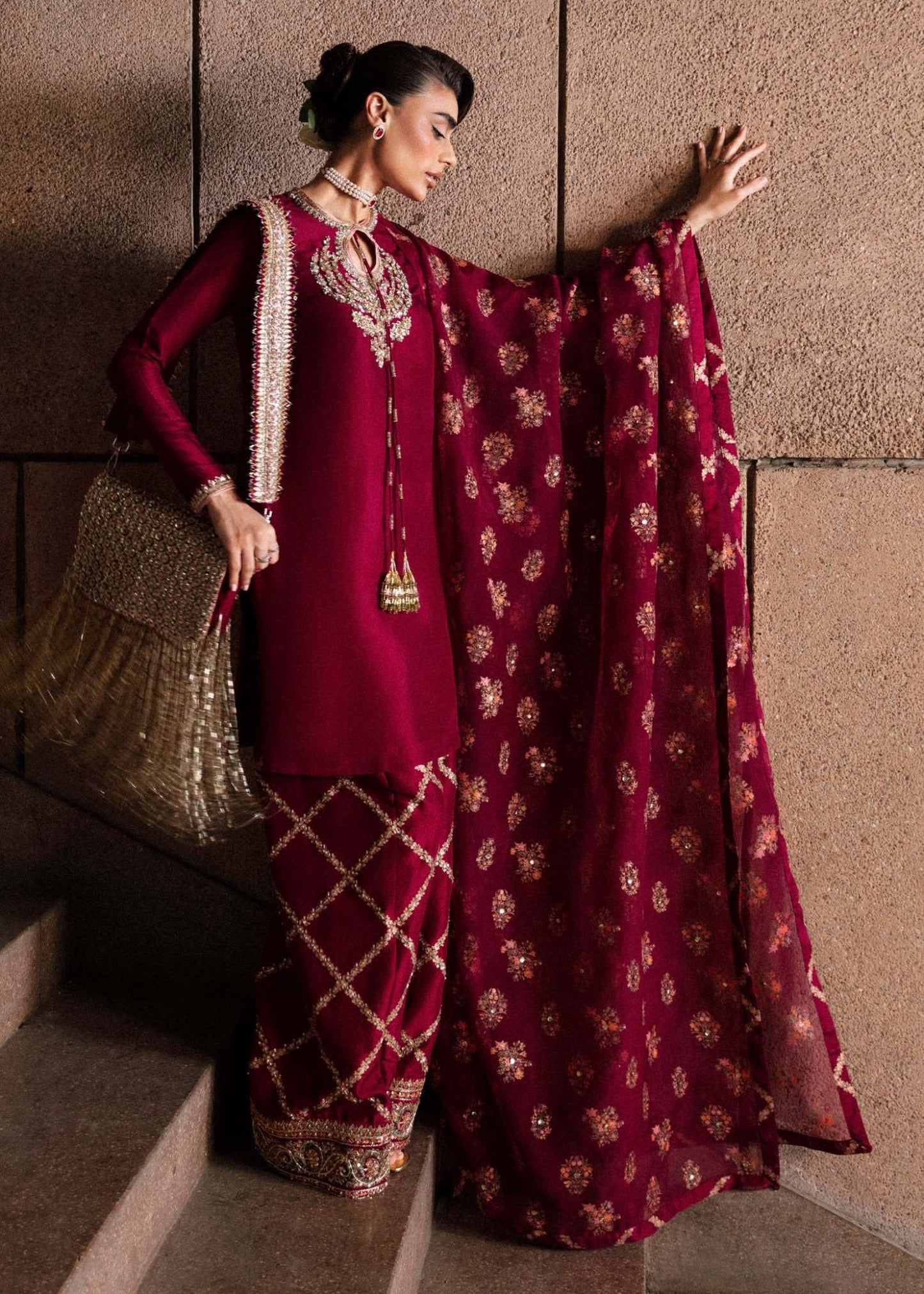 Model wearing an exquisite maroon Merlot dress from Hussain Rehar's Luxury Pret Eid '24 collection. Pakistani clothes online in UK.