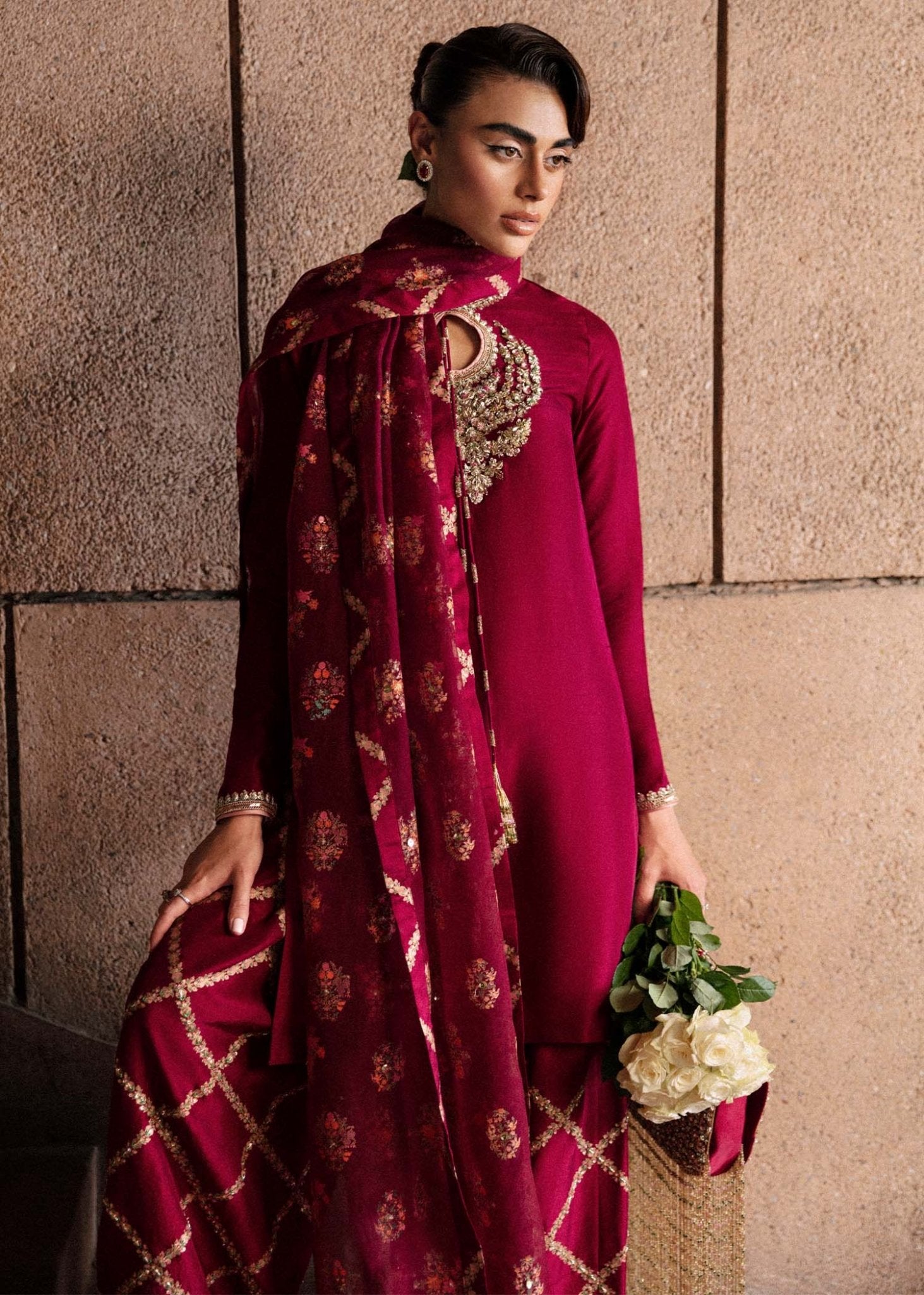 Model wearing an exquisite maroon Merlot dress from Hussain Rehar's Luxury Pret Eid '24 collection. Pakistani clothes online in UK.