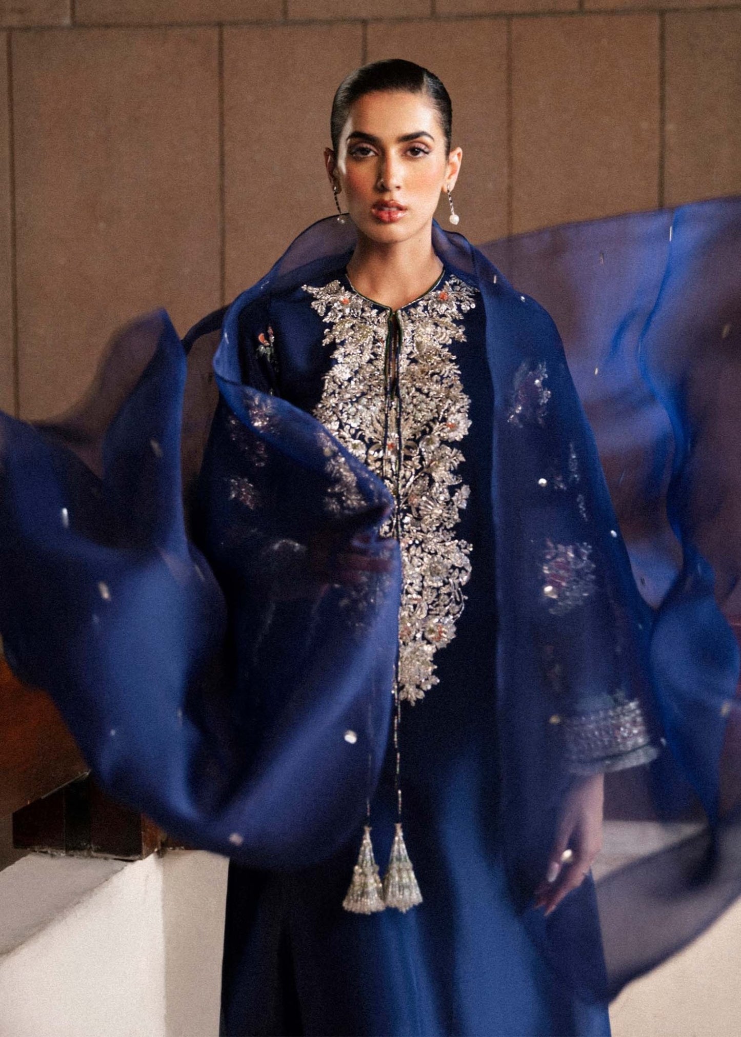 Model wearing a navy blue Saxe dress from Hussain Rehar's Luxury Pret Eid '24 collection. Pakistani clothes online in UK.