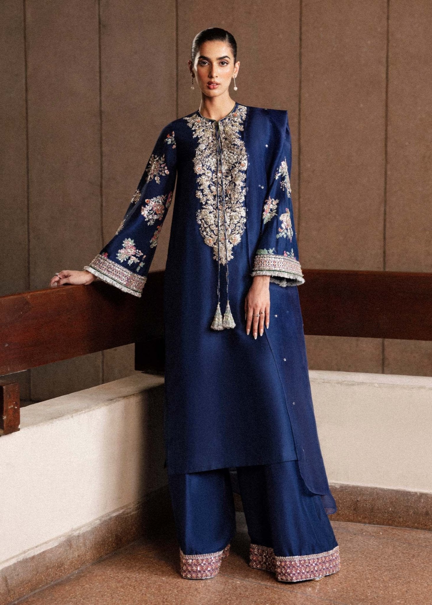 Model wearing a navy blue Saxe dress from Hussain Rehar's Luxury Pret Eid '24 collection. Pakistani clothes online in UK.