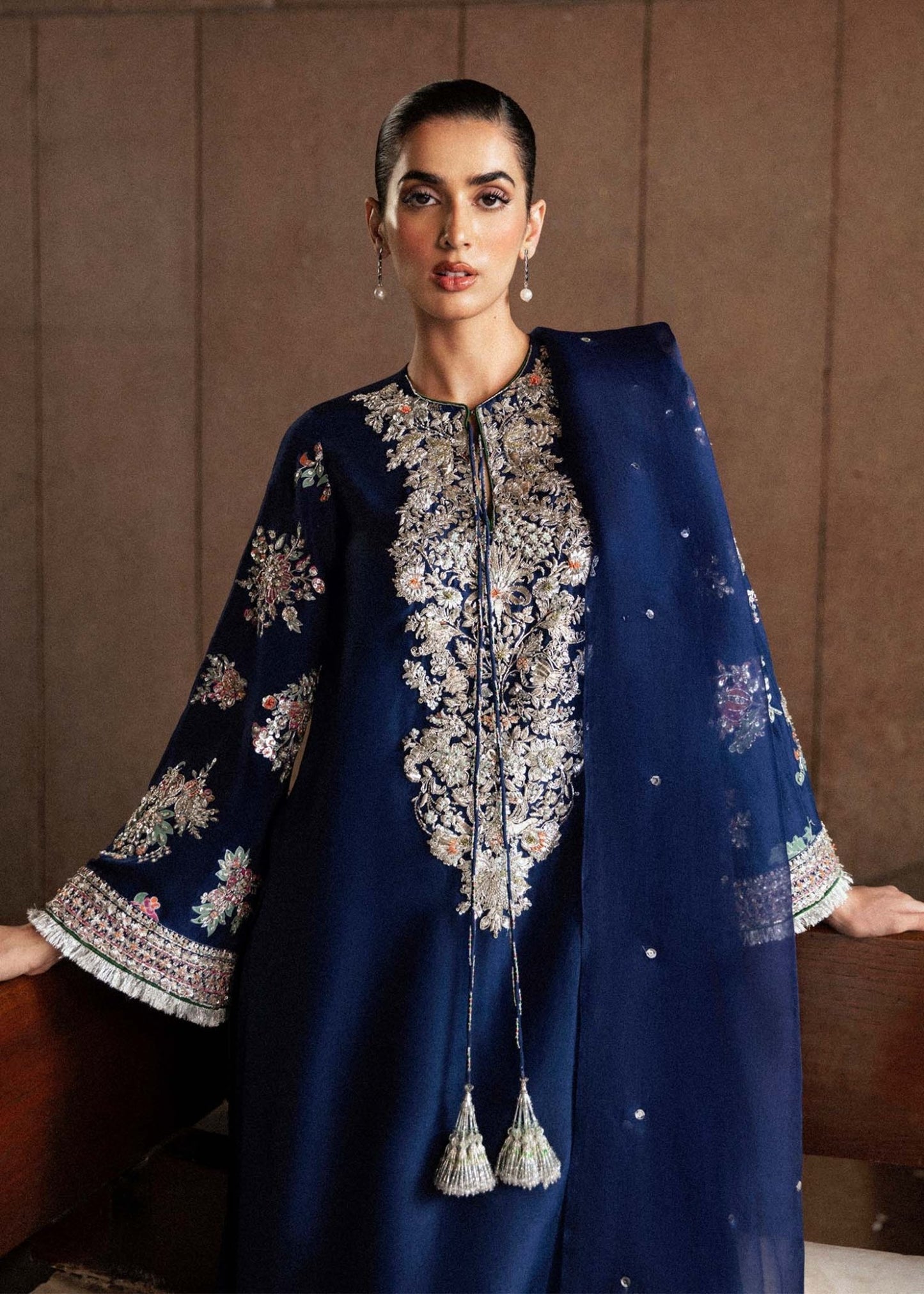 Model wearing a navy blue Saxe dress from Hussain Rehar's Luxury Pret Eid '24 collection. Pakistani clothes online in UK.