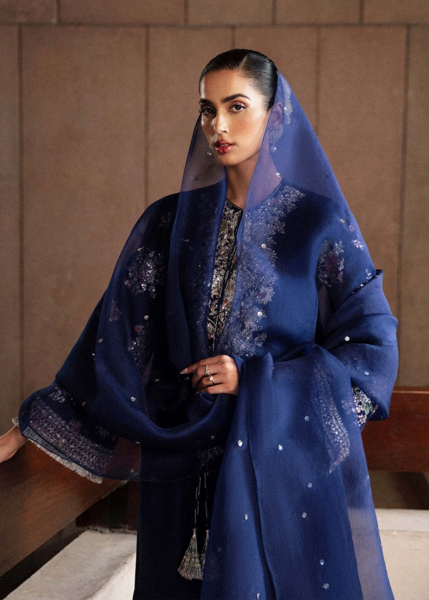 Model wearing a navy blue Saxe dress from Hussain Rehar's Luxury Pret Eid '24 collection. Pakistani clothes online in UK.