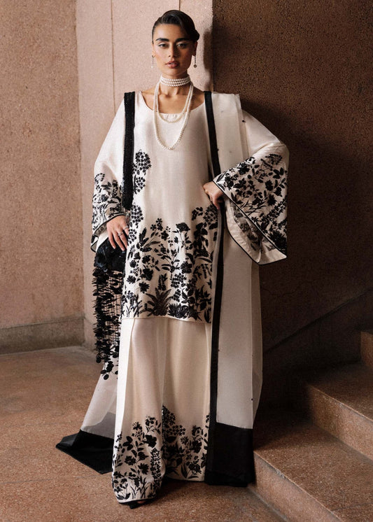 Model wearing Hussain Rehar Tusk dress in ivory and black, perfect for Pakistani designer clothes in UK, readymade wedding clothes, showcasing luxury details for Eid '24.