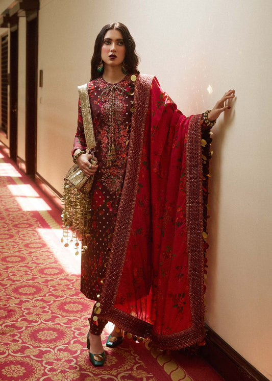 Model wearing Hussain Rehar Aabs dress in deep red with elaborate gold embroidery, ideal for Eid and Pakistani lawn suits in the UK.