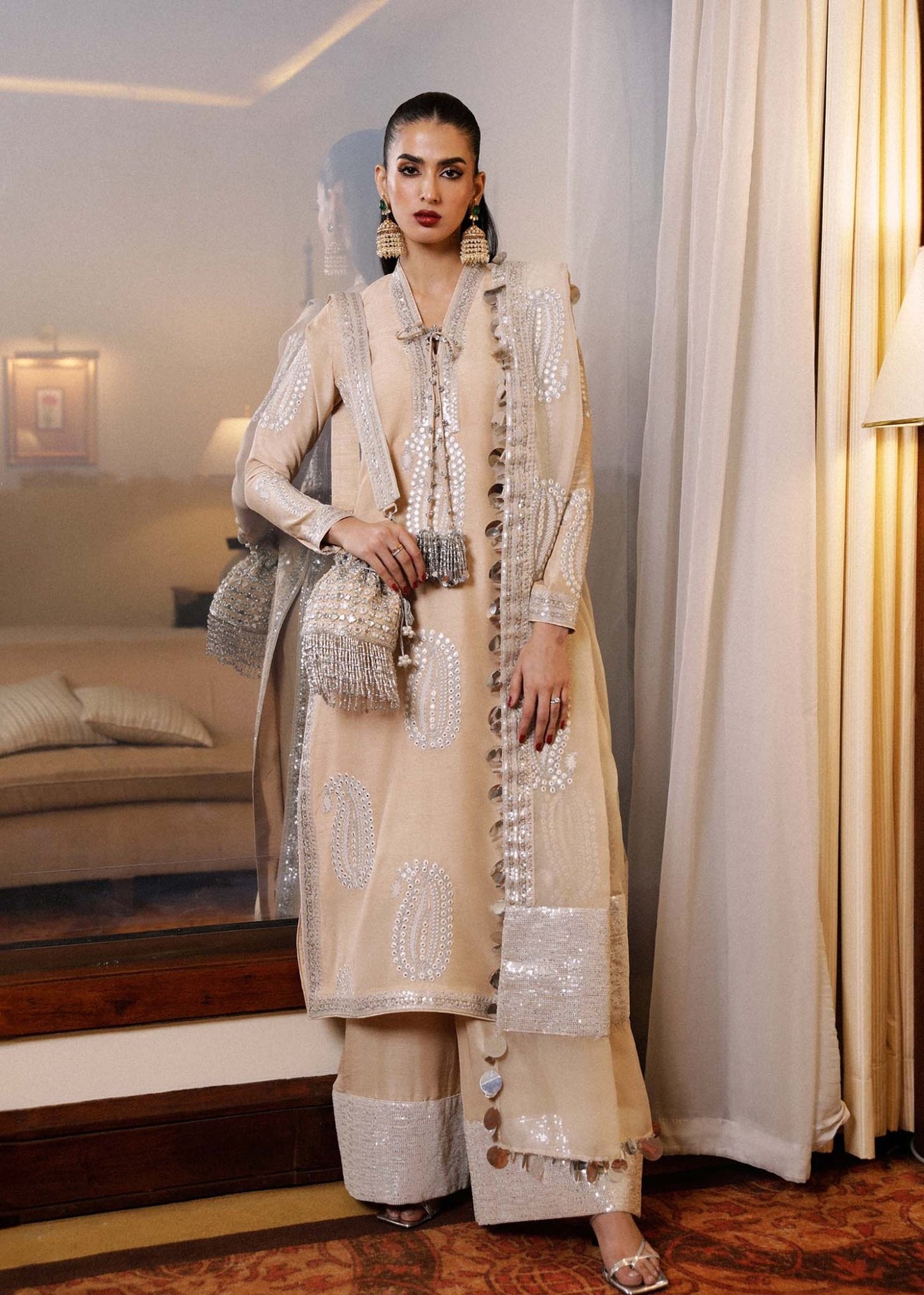 Model in Hussain Rehar Moh beige embellished Pakistani luxury pret suit, ideal for Eid.