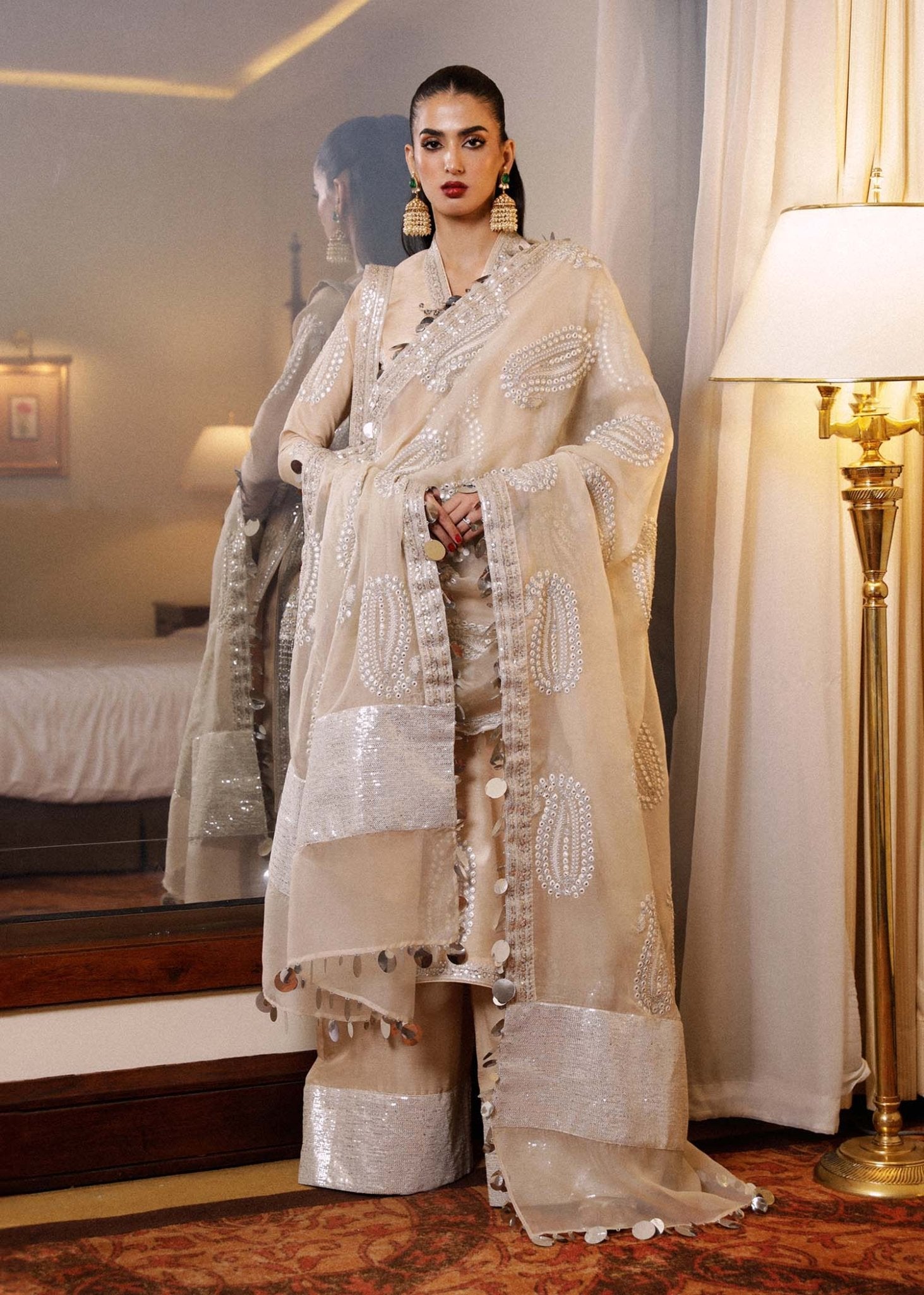 Model wearing a beige Moh dress from Hussain Rehar's Luxury Pret SS/24 collection. Pakistani clothes online in UK.