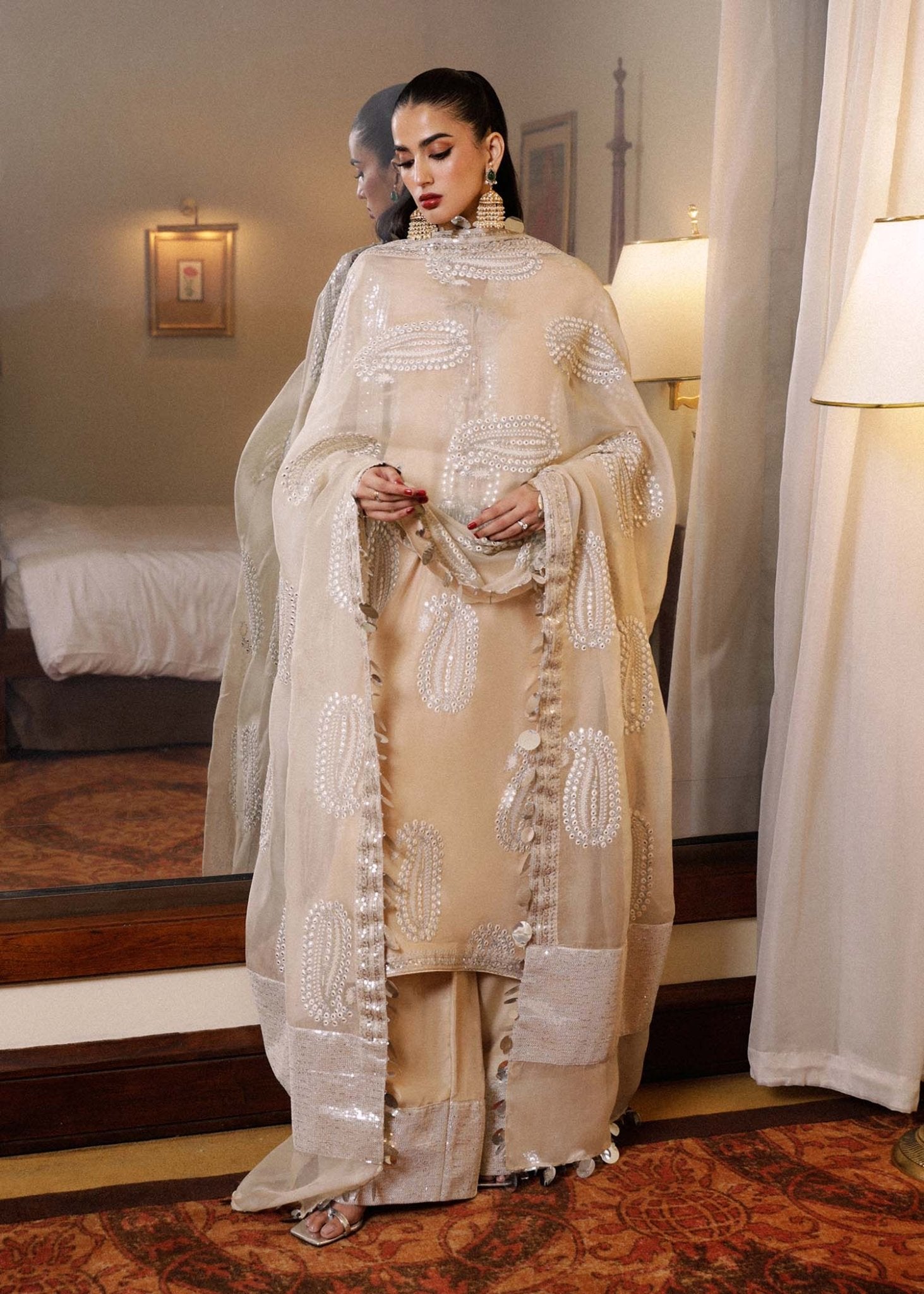 Model wearing a beige Moh dress from Hussain Rehar's Luxury Pret SS/24 collection. Pakistani clothes online in UK.