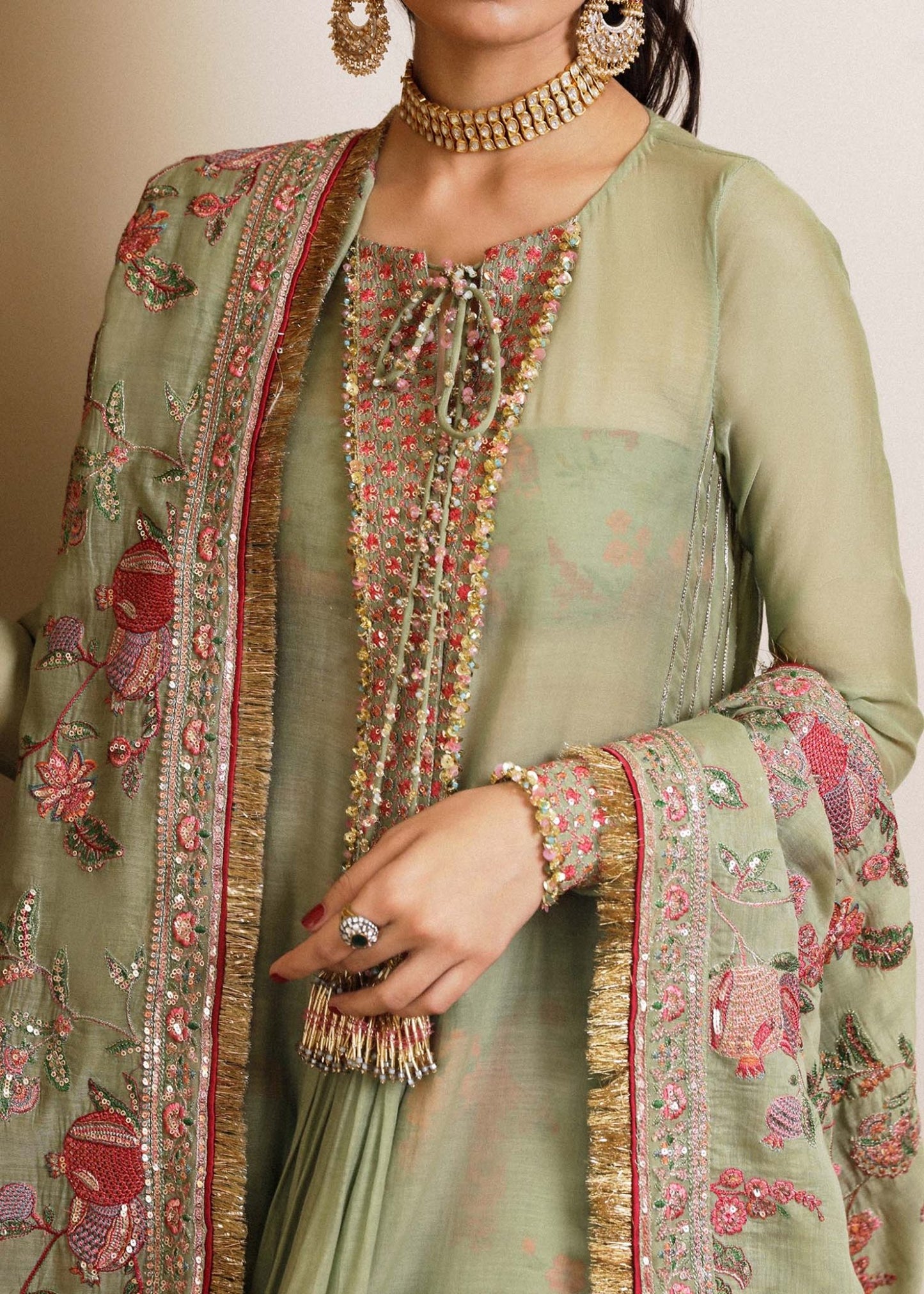 Model wearing a green Pahari dress from Hussain Rehar's Luxury Pret SS/24 collection. Pakistani clothes online in UK.