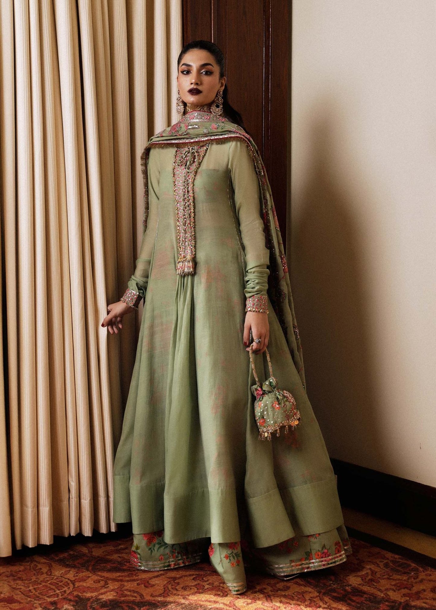 Model in Hussain Rehar Pahari olive green embellished luxury pret suit, perfect for Eid.