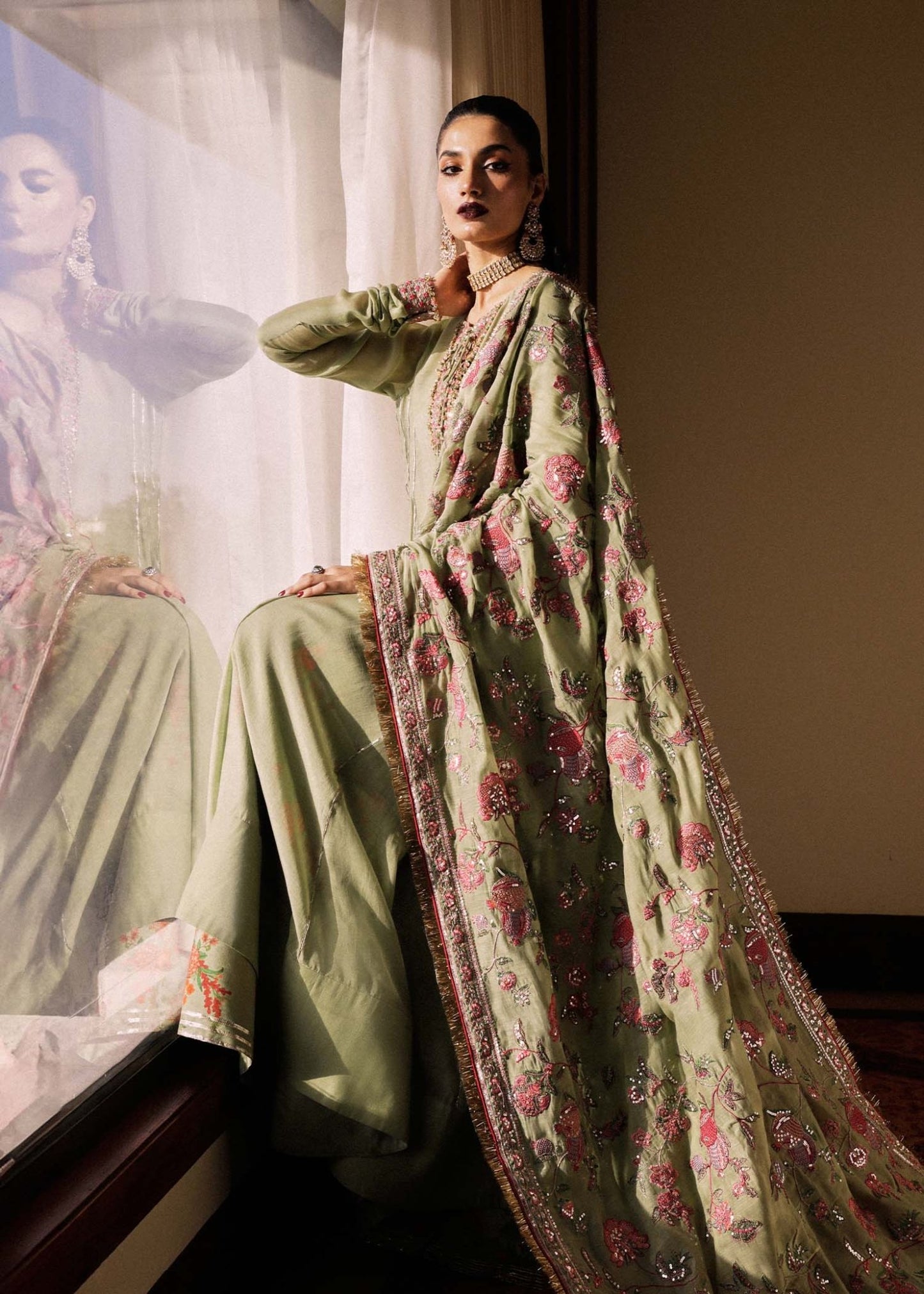 Model wearing a green Pahari dress from Hussain Rehar's Luxury Pret SS/24 collection. Pakistani clothes online in UK.