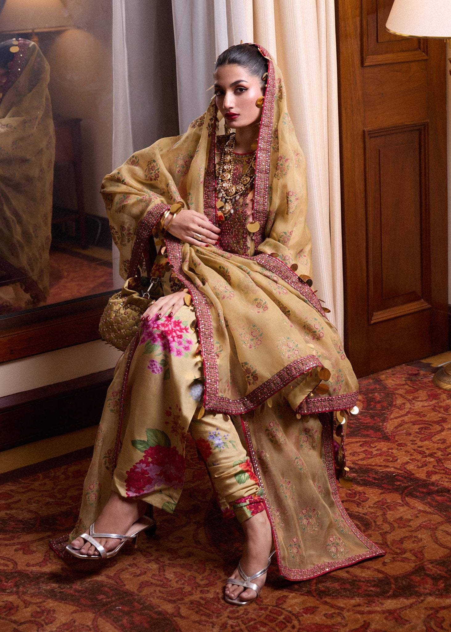 Model wearing a gold Seagh dress from Hussain Rehar's Luxury Pret SS/24 collection. Pakistani clothes online in UK.