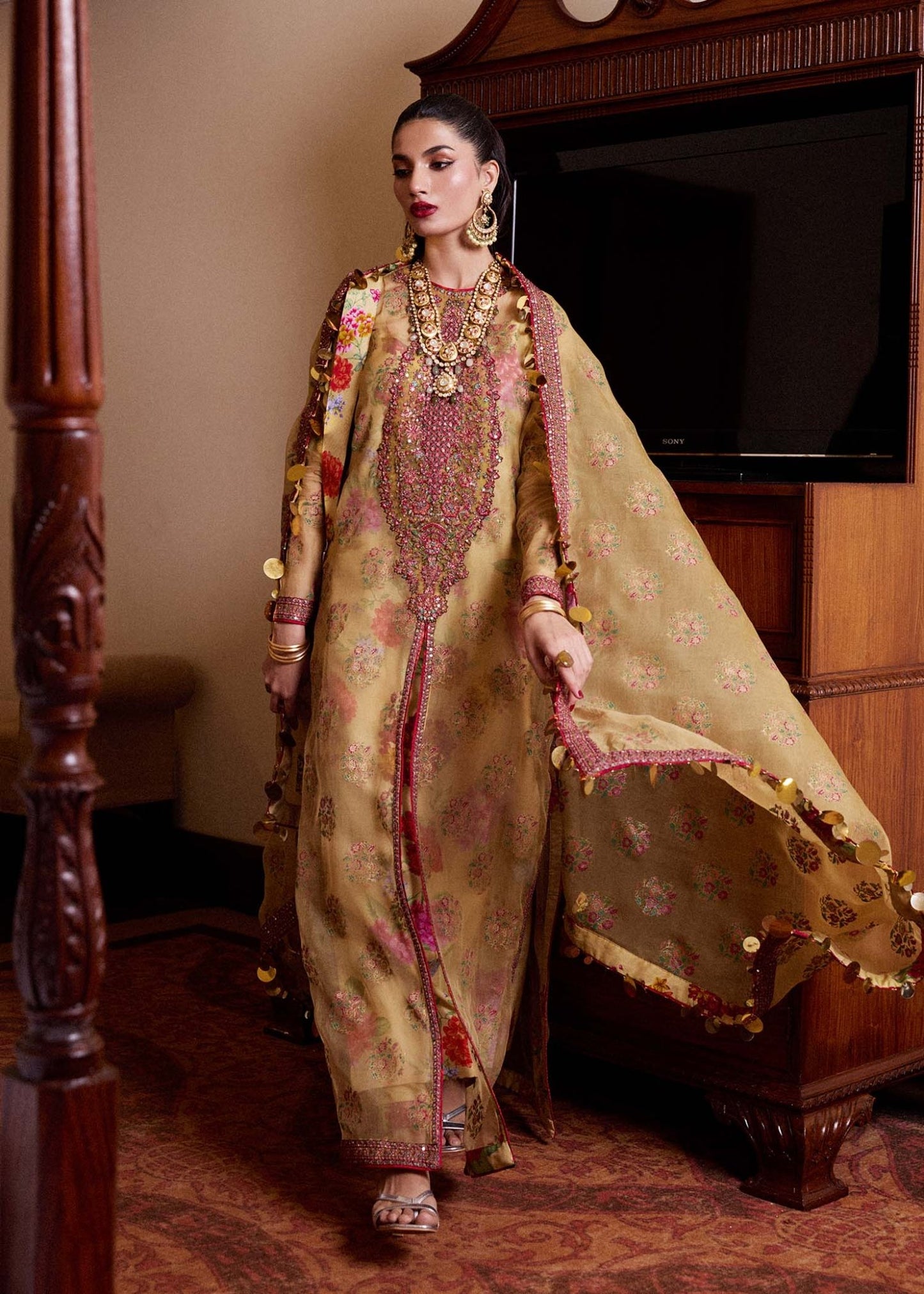 Model wearing a gold Seagh dress from Hussain Rehar's Luxury Pret SS/24 collection. Pakistani clothes online in UK.