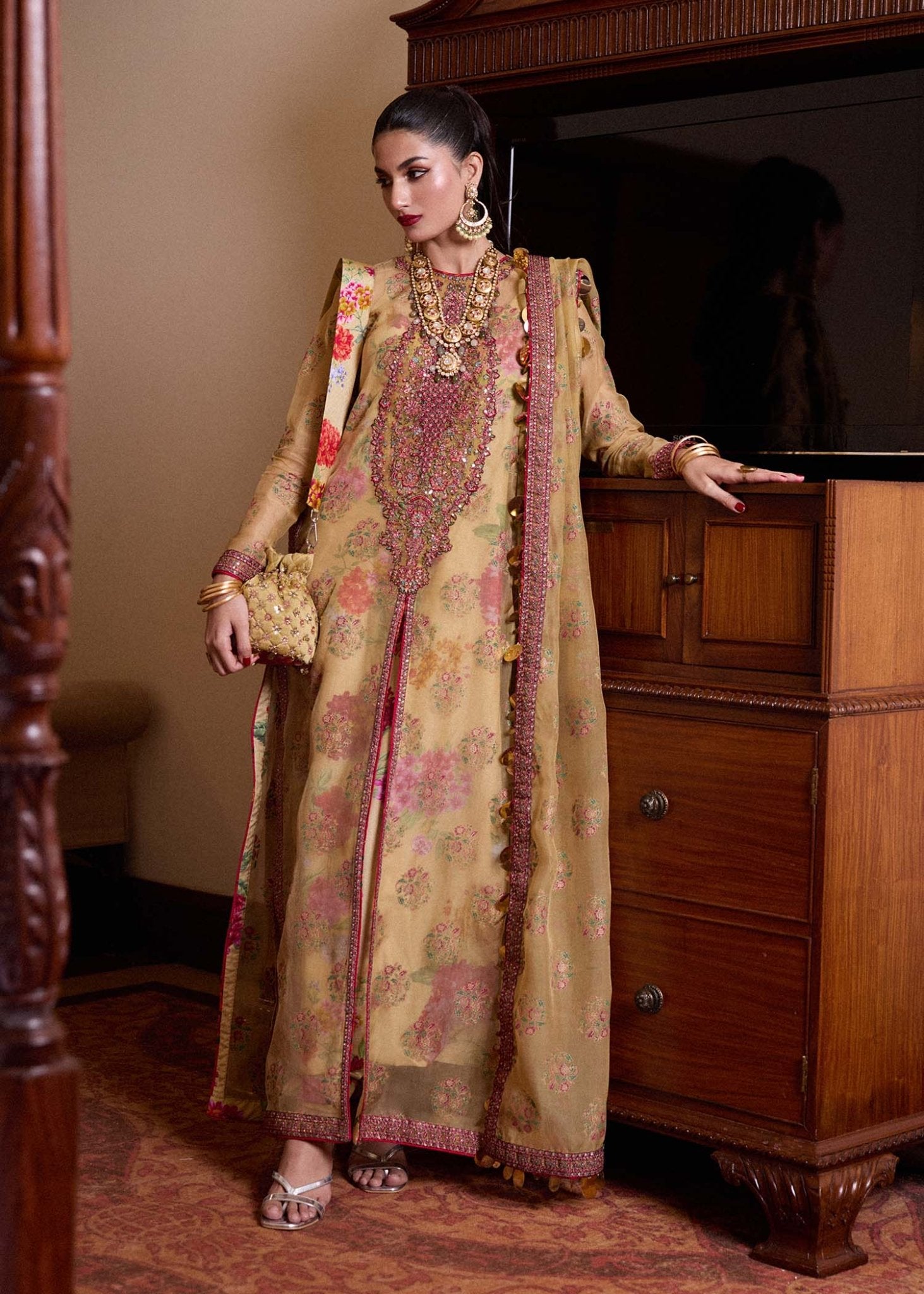 Model wearing a gold Seagh dress from Hussain Rehar's Luxury Pret SS/24 collection. Pakistani clothes online in UK.