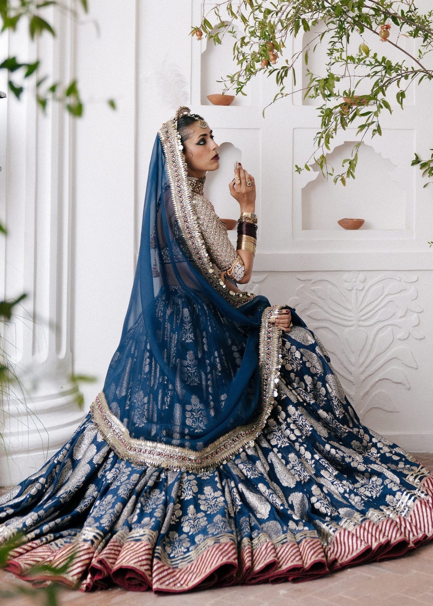 Hussain Rehar's Neelam lehenga, choli and duppatta from Rehar Nagar Bridals'24 in rich blue with intricate silver embroidery, perfect for luxury bridal wear. Available online in the UK, ideal for formal Pakistani bridal attire.