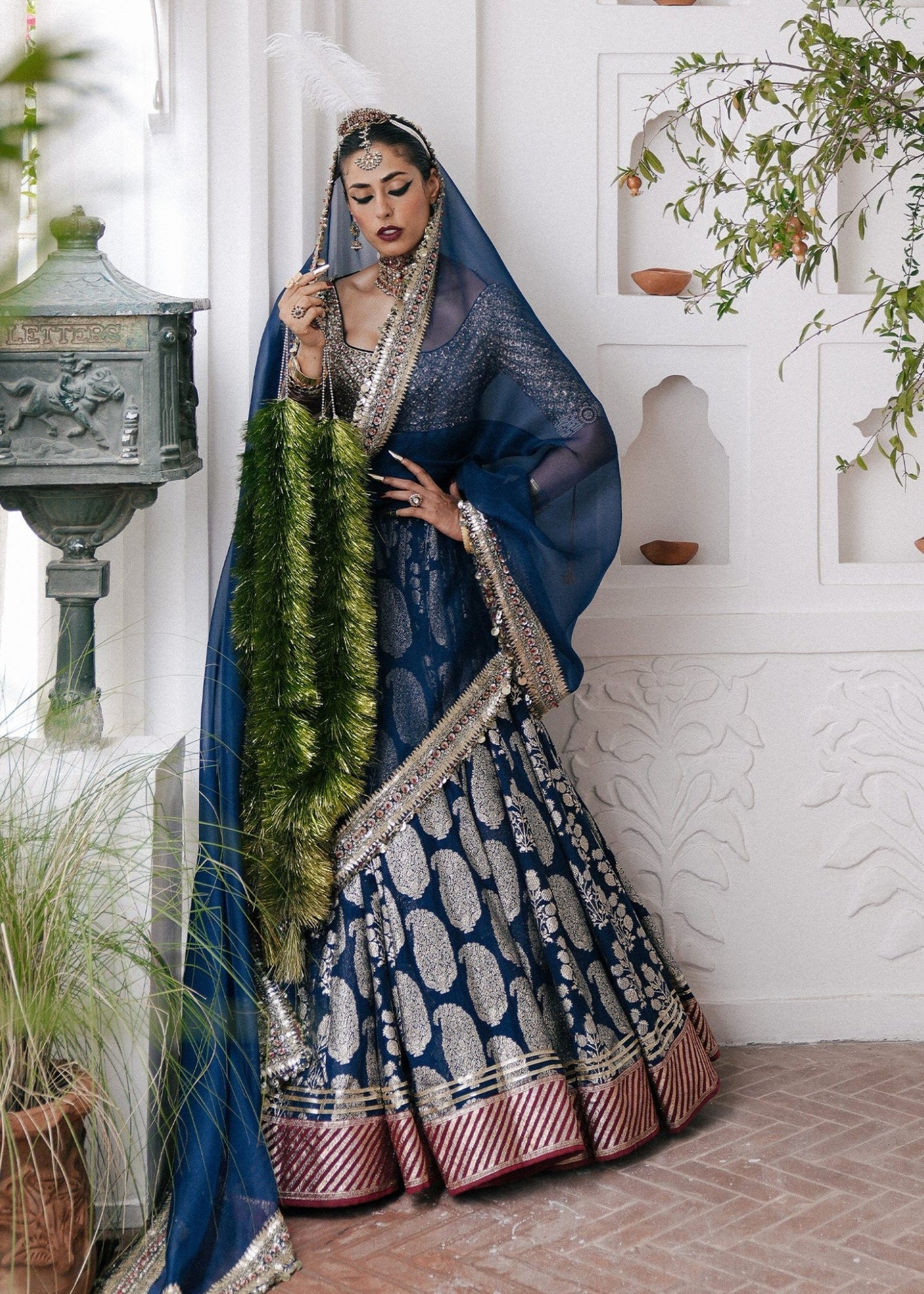 Hussain Rehar's Neelam lehenga, choli and duppatta from Rehar Nagar Bridals'24 in rich blue with intricate silver embroidery, perfect for luxury bridal wear. Available online in the UK, ideal for formal Pakistani bridal attire.